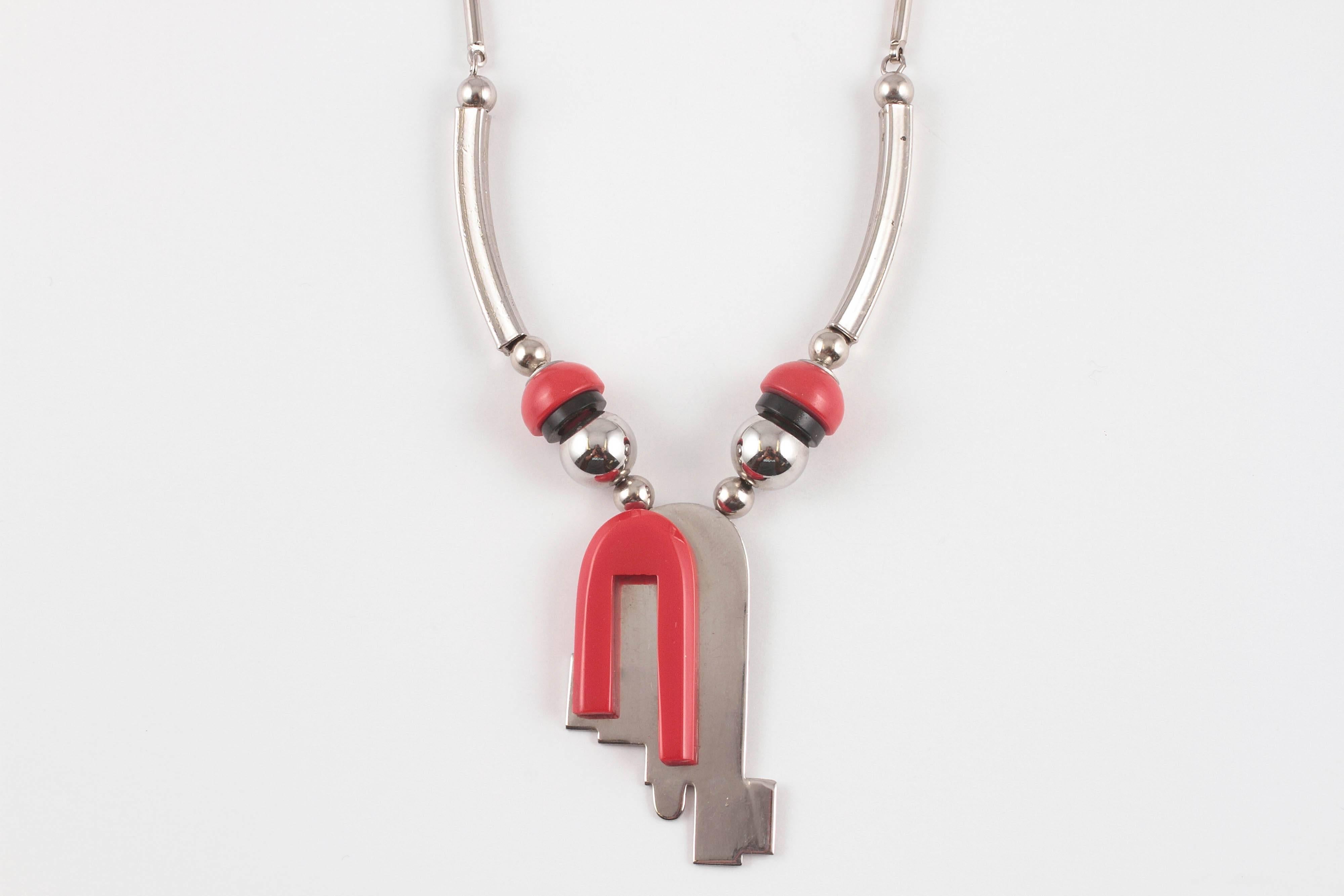 A great example of German Art Deco design.  The Chrome tubular design chain  suspends red and black Galaith in a decidedly modern look.  