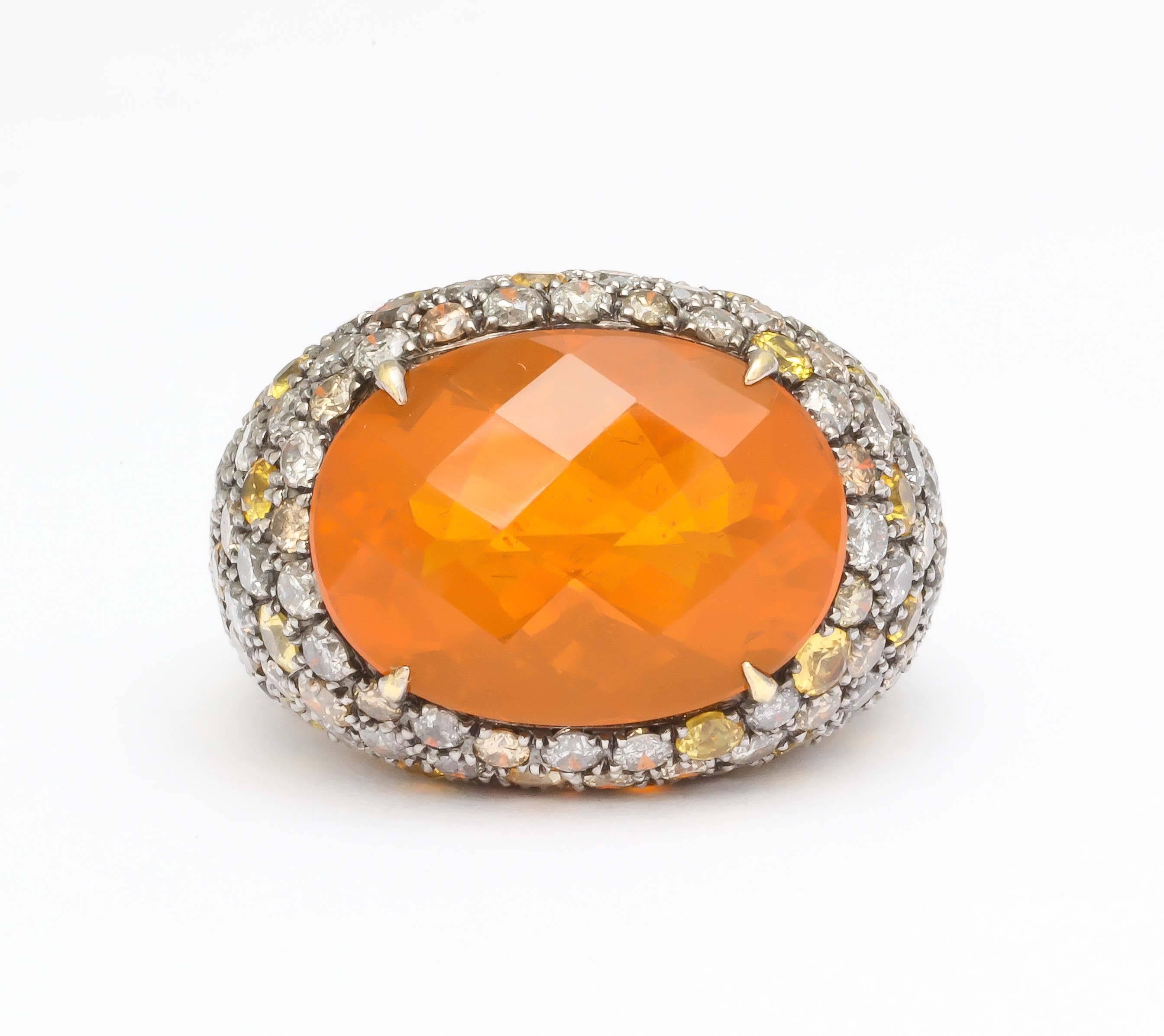 18k yellow and white gold oval fire opal ring with pave gray & brown diamond and sapphire mounting 
center oval opal weighs approximately 9.4 ct.
diamonds weigh approximately 5.00 ct. 
yellow & orange sapphires approximately 2.75 ct.