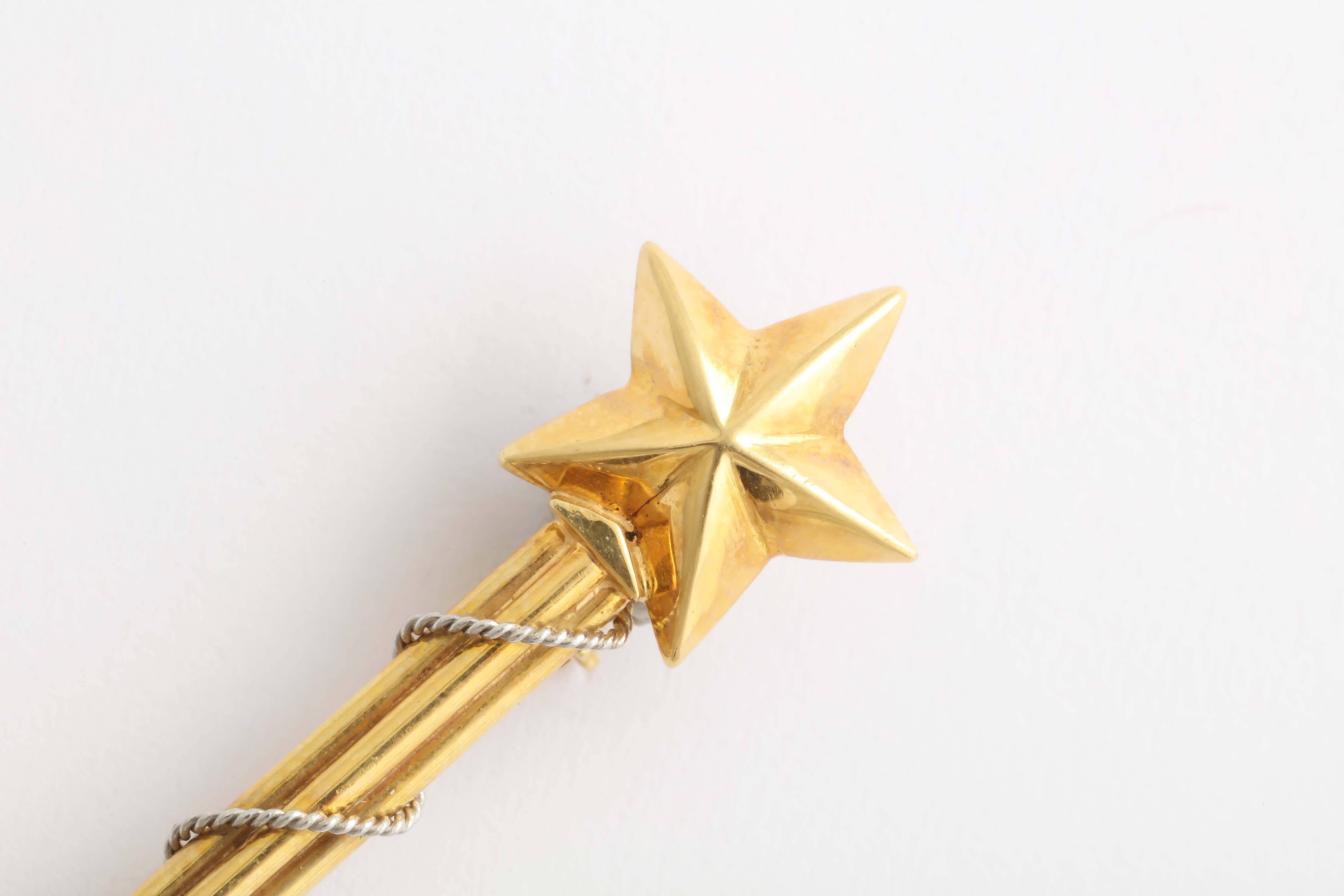 Amusing  18 kt gold Magic Wand pin. The wand is topped with a mystical star for extra conjuring power.At the bottom of the wand, is a cabochon sapphire, the birthstone for September.  Kings wore sapphires around their necks as a powerful defense