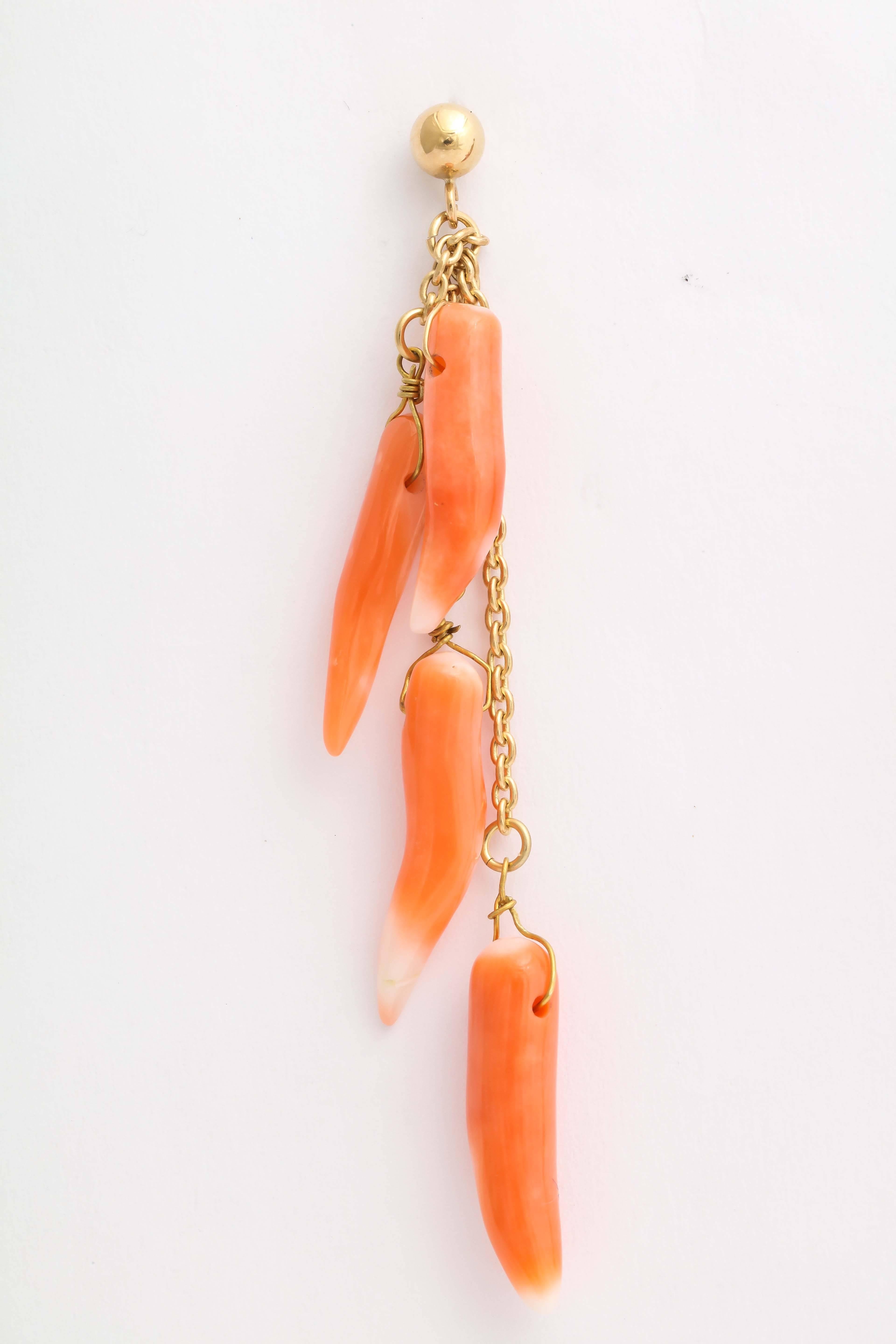 Four horn shaped natural orange and white corals dangle on various length 14 kt gold chains on each earring. The top is a 14 kt gold ball and post. Total length 2 1/4 in.