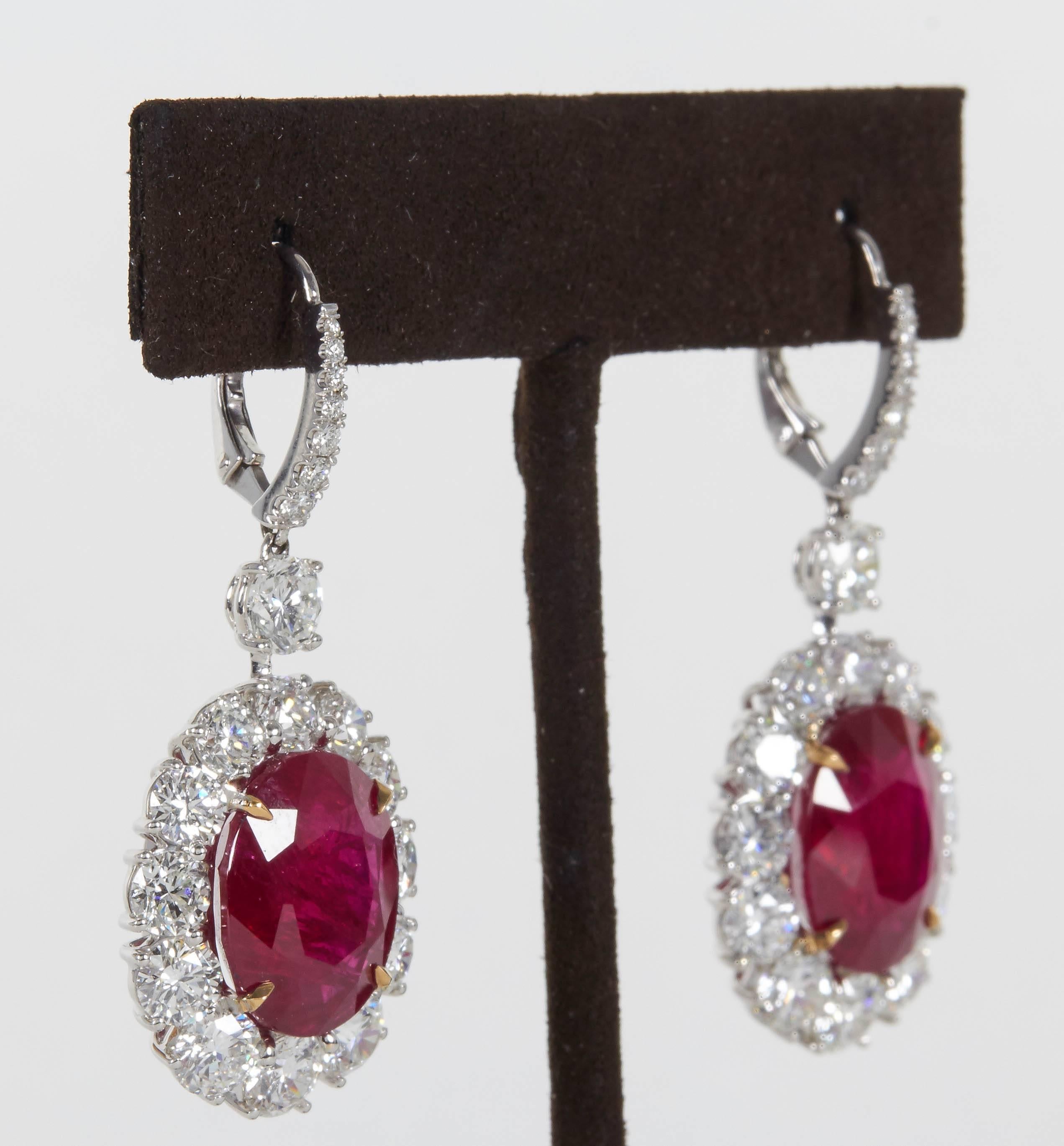 

Pictures do not do this earring justice! 

Incredible ruby and diamond earrings in a wearable design. 

20.49 carats of oval Ruby with incredible color and nice brilliance. 

9.21 carats of round brilliant cut diamonds F/G color VS