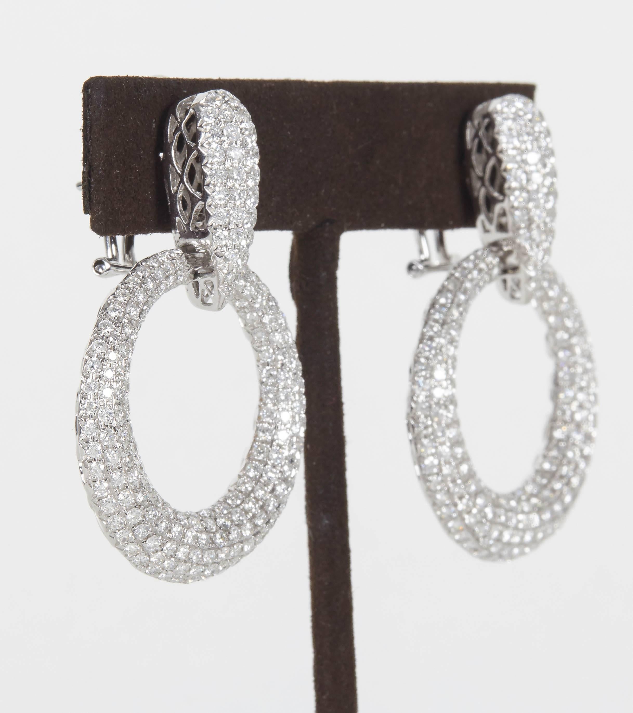 

A stunning pair of fashionable diamond earrings.

5.22 carats of sparkle! 

The diamonds are F/G color and VS clarity set in 18k white gold.

Just under approximately 1 3/4 inches from top to bottom, 1 1/4 inches at its widest point. 