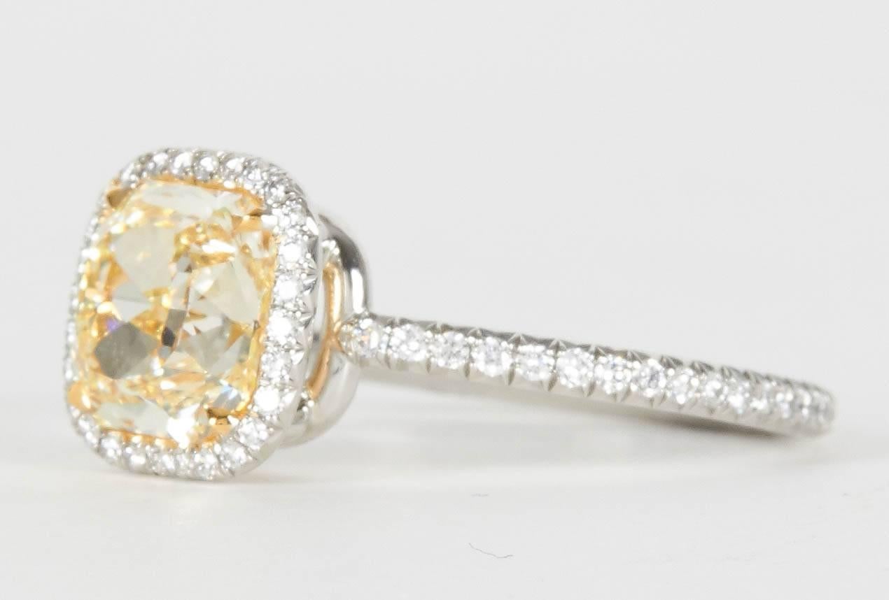 

The most beautiful yellow cushion cut diamond!

The center diamond is almost flawless!

Incredibly unique halo mounting, handmade only a few skilled jewelers are able to create a ring this delicate. 

2.02 carat GIA certified Fancy Light