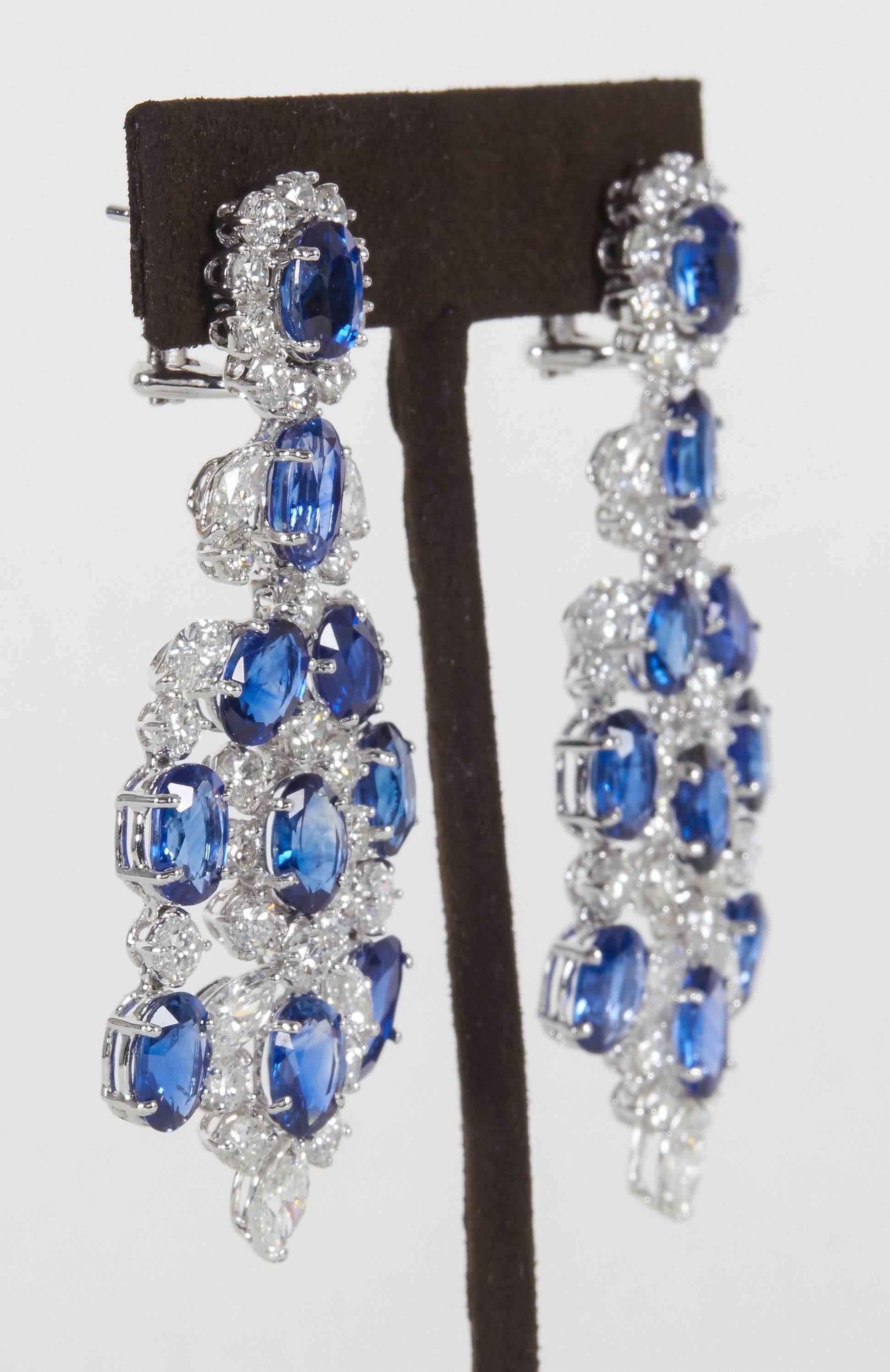 

Fabulous earrings set in a timeless design. 

30.16 carats of fine blue sapphires

12.73 carats of FG color VS clarity diamonds

18k white gold 

Approx 2.5 inches in length and just over an inch wide