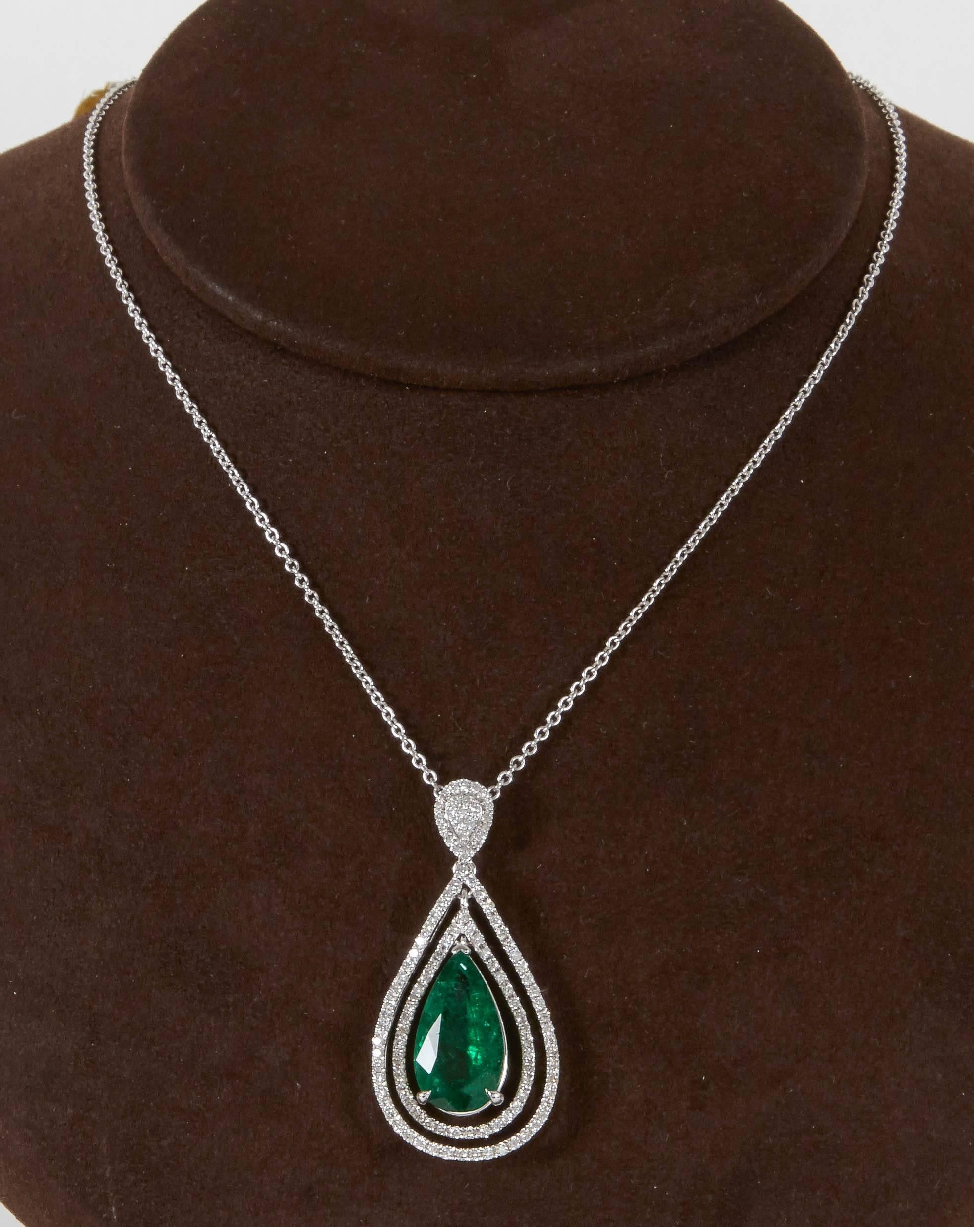 

A beautiful green emerald and diamond pendant. 

5.50 carat certified pear shape Green Emerald 

1.48 carats of white round brilliant cut diamonds 

18k white gold 

The pendant hangs from a 16 inch 18k white gold chain