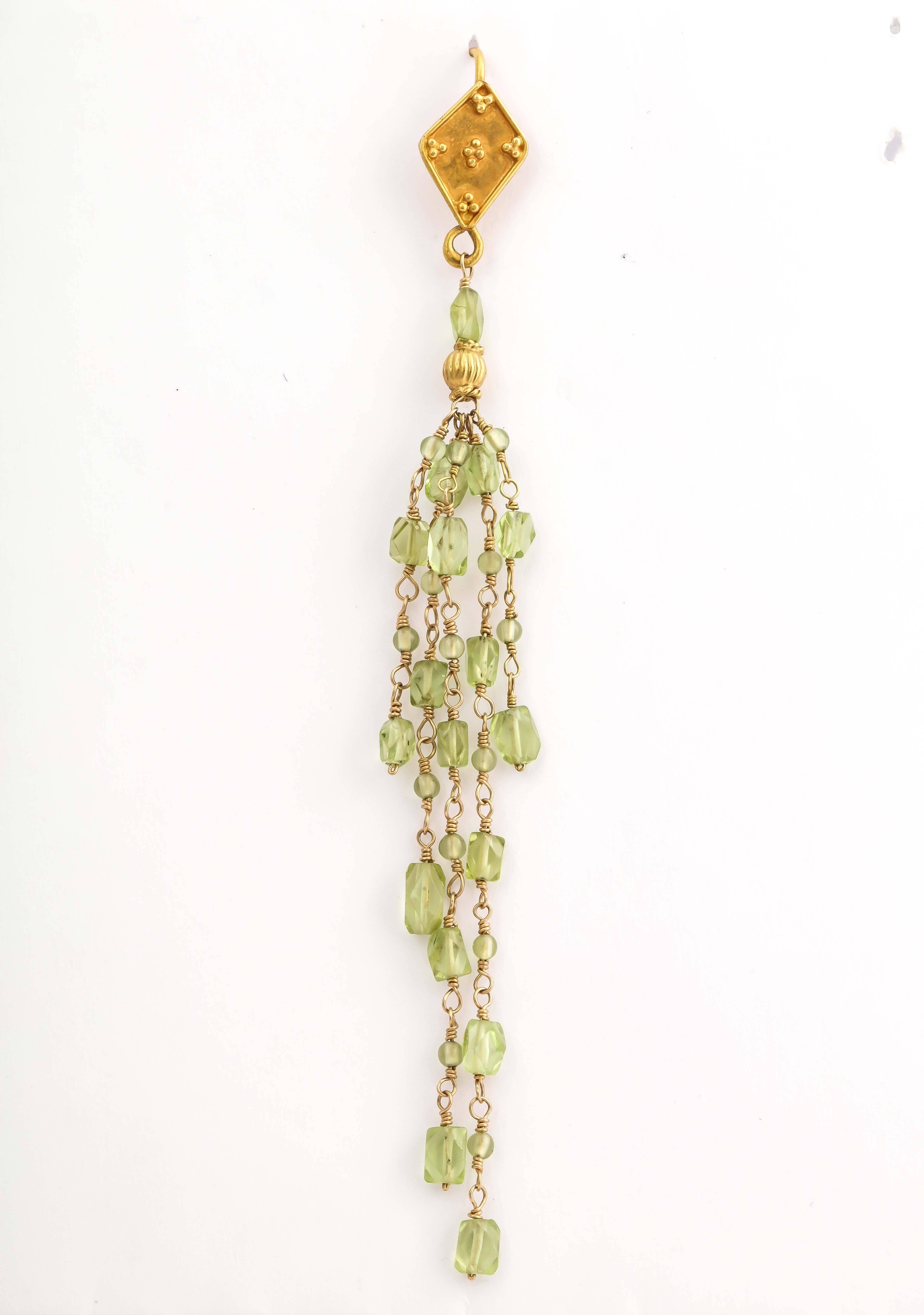 Four inch long, elegant and classical wire wrapped peridot bead earrings. The top is granulated with gold beads and the earring hangs from kidney shaped ear wires. Great earrings for day or evening. You will look like a greek goddess.