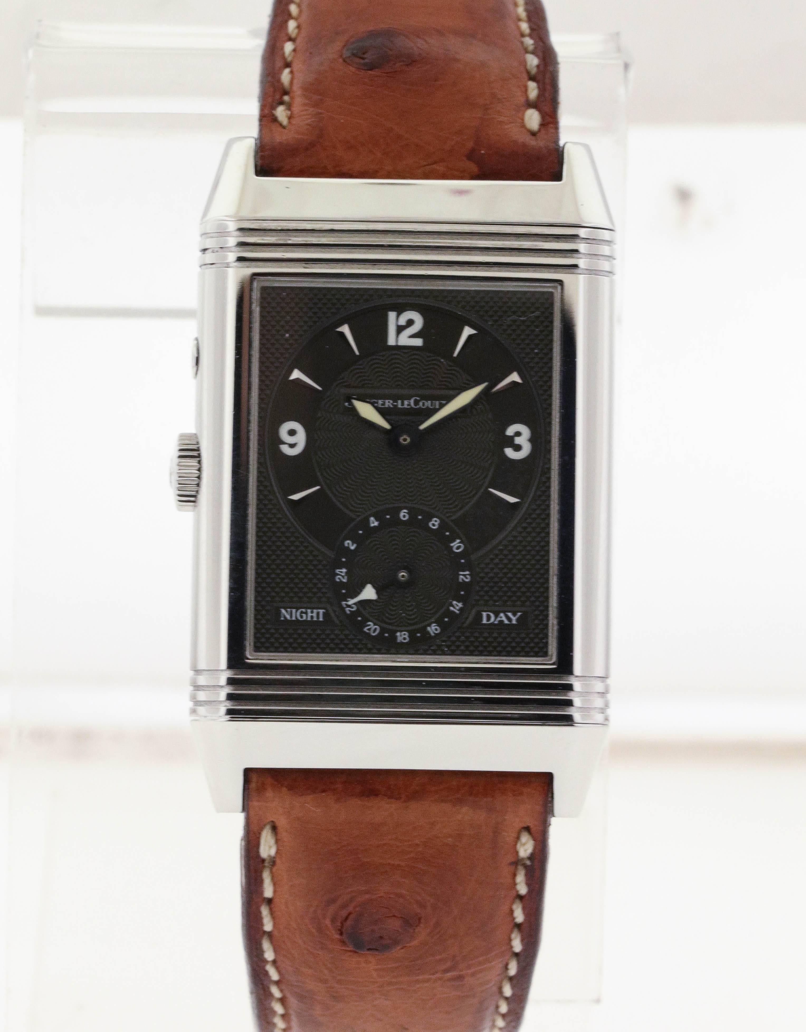 Stainless steel Jaeger LeCoultre Reverso Duoface, Ref. 270.8.54, circa 2000, is a rectangular, two time zone, double-face, stainless steel wristwatch with steel Jaeger LeCoultre deployant clasp. The 26mm x 42mm case has a reeded bezel. The dial on