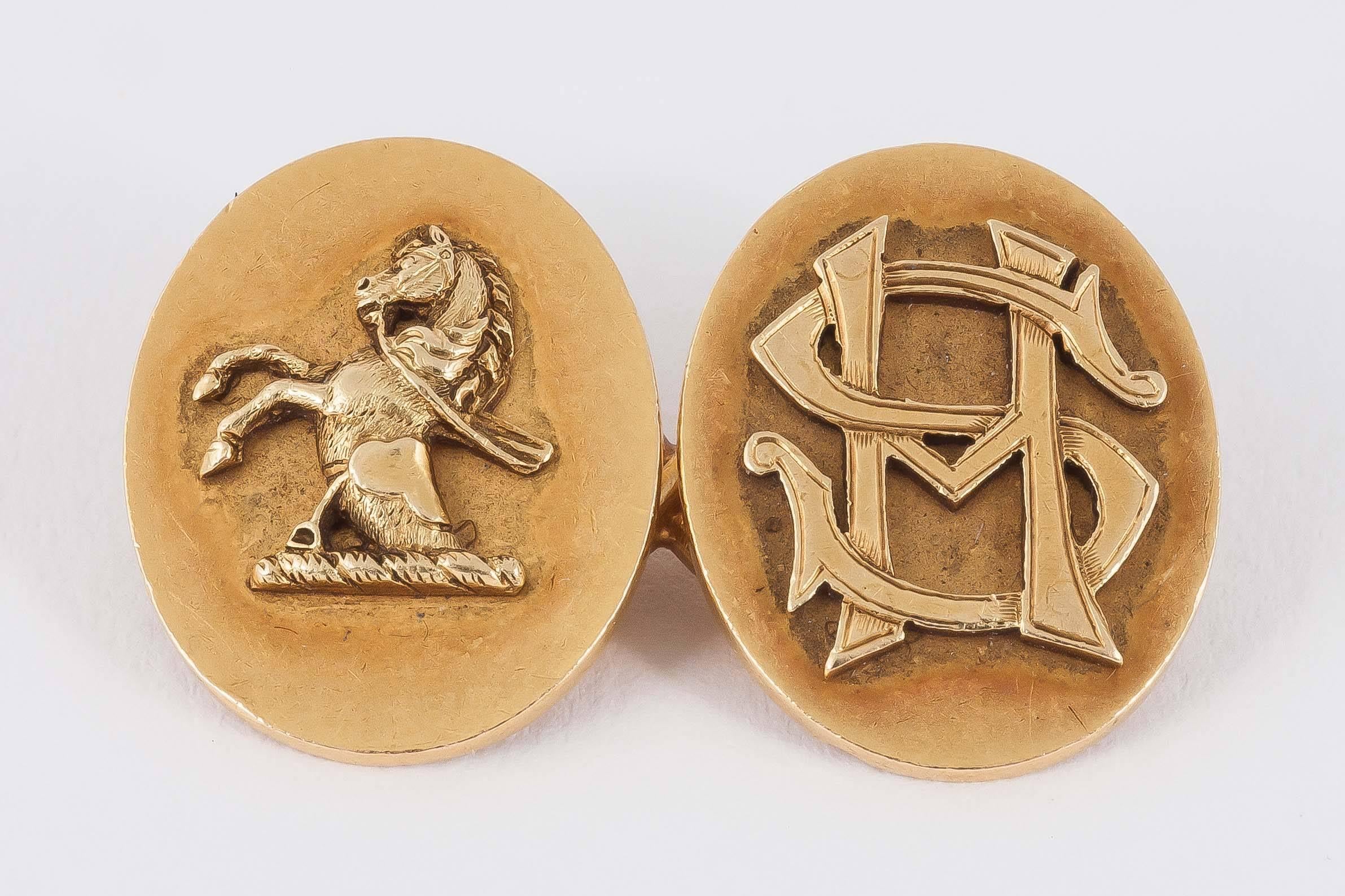 A heavy pair of fine quality, 19th century,oval gold cufflinks,stamped 18ct,with applied rearing stallion and initials S M or M S. English , c 1860/70