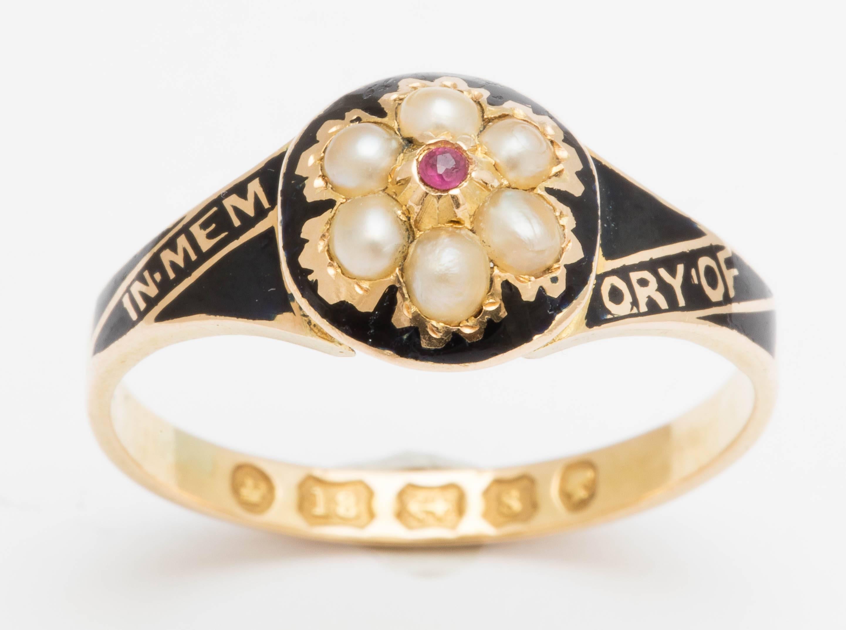 Beautifully enameled on 18K yellow gold, this cluster ring is set with pearls and a central ruby. It was made in memory of W. F. Arnold after his death, March 31st, 1866. In perfect condition with hallmarking on the interior of the band. 