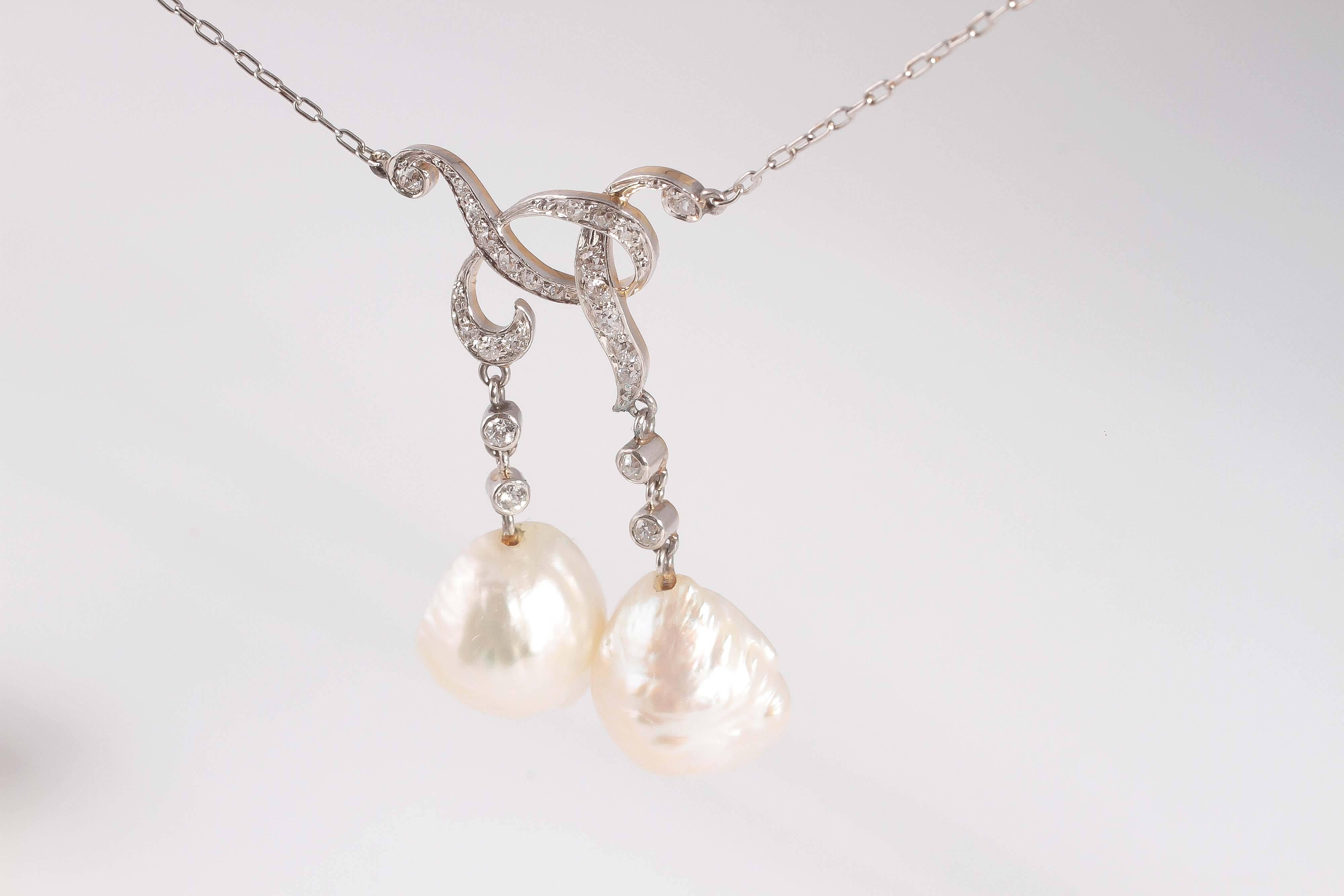 Complete with a GIA report stating that the pearls are natural, this necklace is circa 1900 and is both eye-catching and unique.  0.42 carats of diamonds.