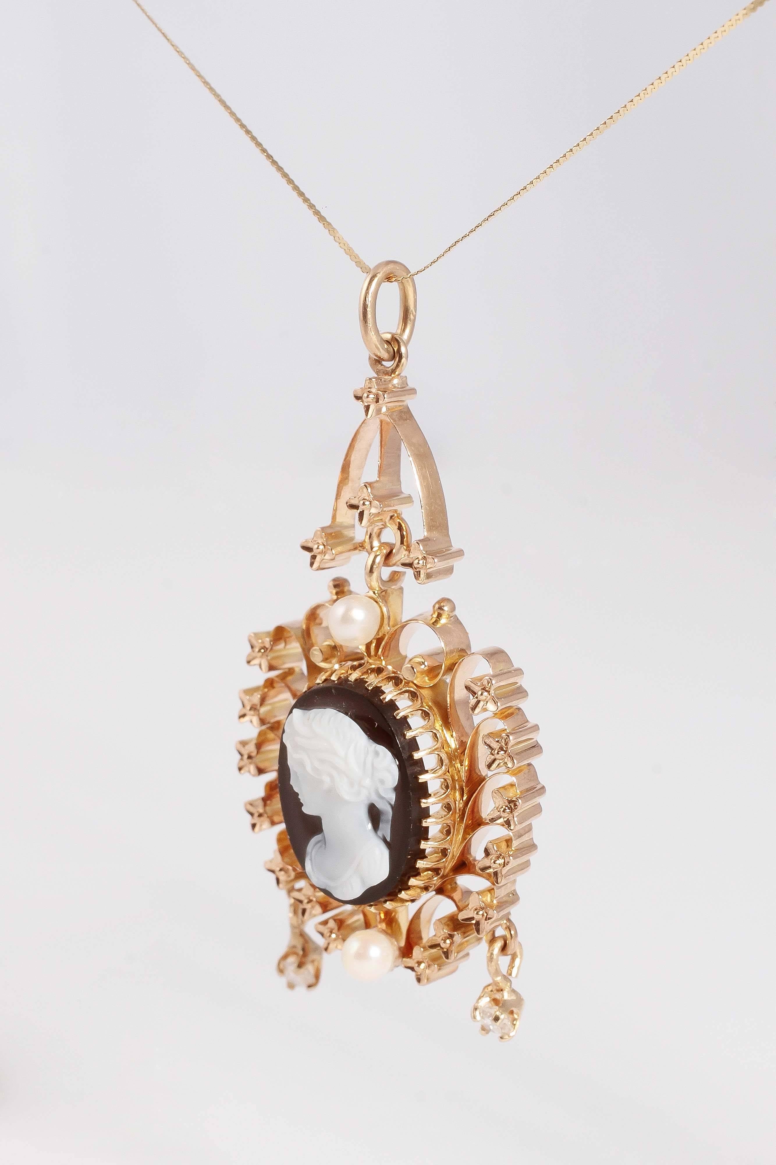 A treasure from the Edwardian era.  Beautiful carved onyx cameo, with accent diamonds and pearls.  The pendant measures approximately 15 inches in length. 
