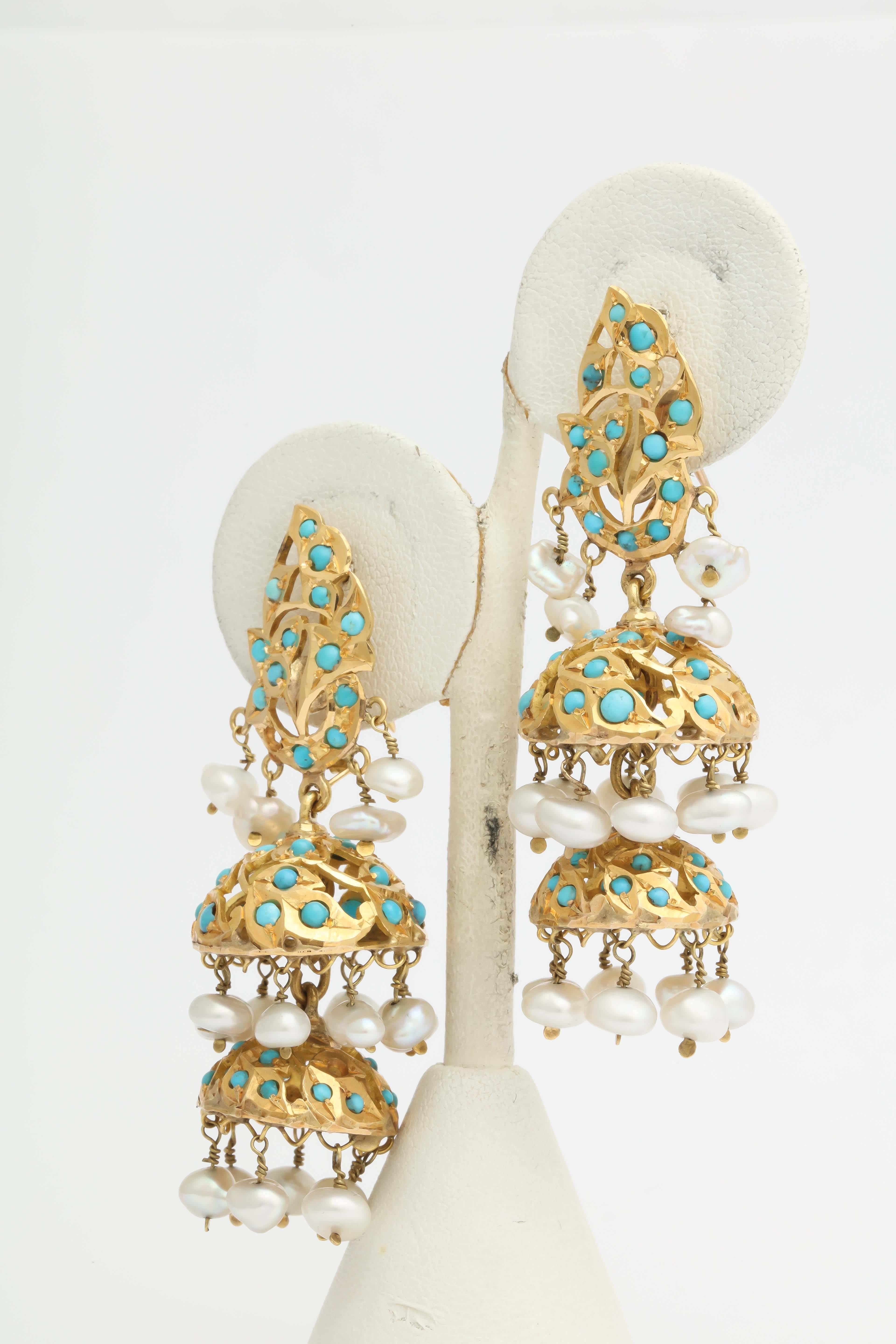 18kt Yellow Gold Fancy 3 Tier Chandelier Earrings Composed Of Numerous Cabochon Turquoises And Further Embellished With 3 Tiers Of High Quality i pearls. Tops Of Earrings Designed With A Leaf Motif Set With Turquoises and Mississippi Pearls. Back Of