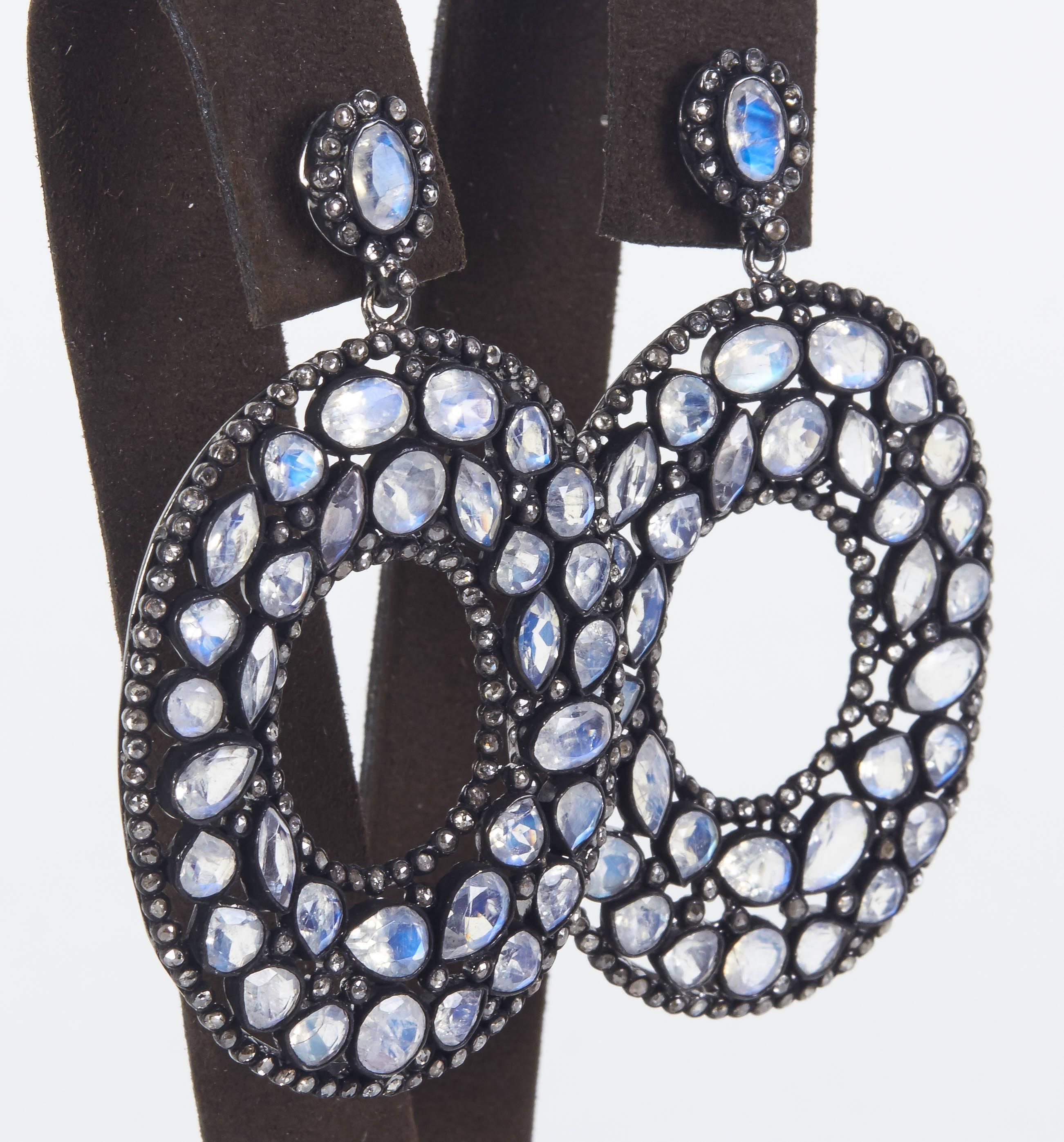 

A fabulous pair of statement earrings -- beautiful design and sparkle. 

19.40 carats of moonstone

3.60 carats of diamond

Approximately 2.36 inches in length and just under 1.5 inches at its widest point. 

Set in silver 