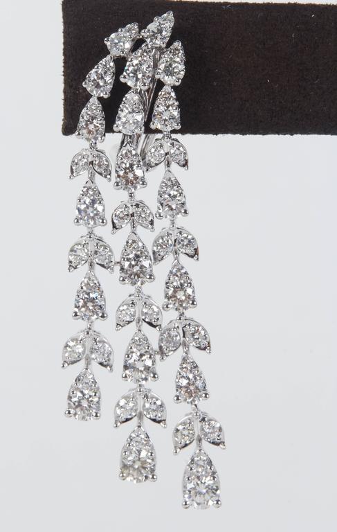 

A stunning pair of earrings!  Almost 7 carats of sparkle!

6.87 carats of round brilliant cut diamonds set in pear and marquise shaped 18k white gold. The round stones give the earrings more sparkle and a unique look.

Approximately half an