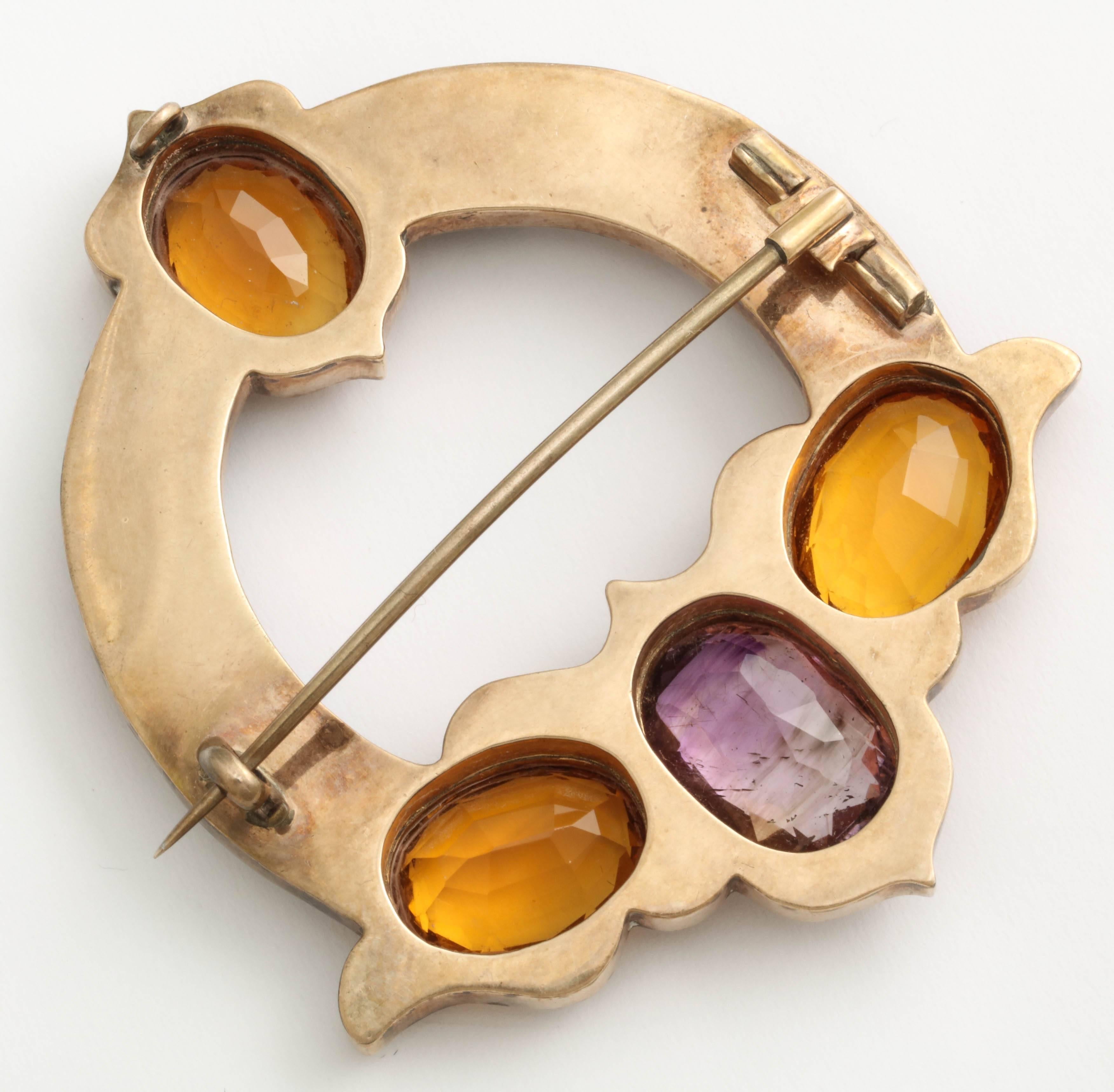 A beautiful example of Scottish agate jewelry, this gold brooch is set with six hardstones, citrine and amethyst. 