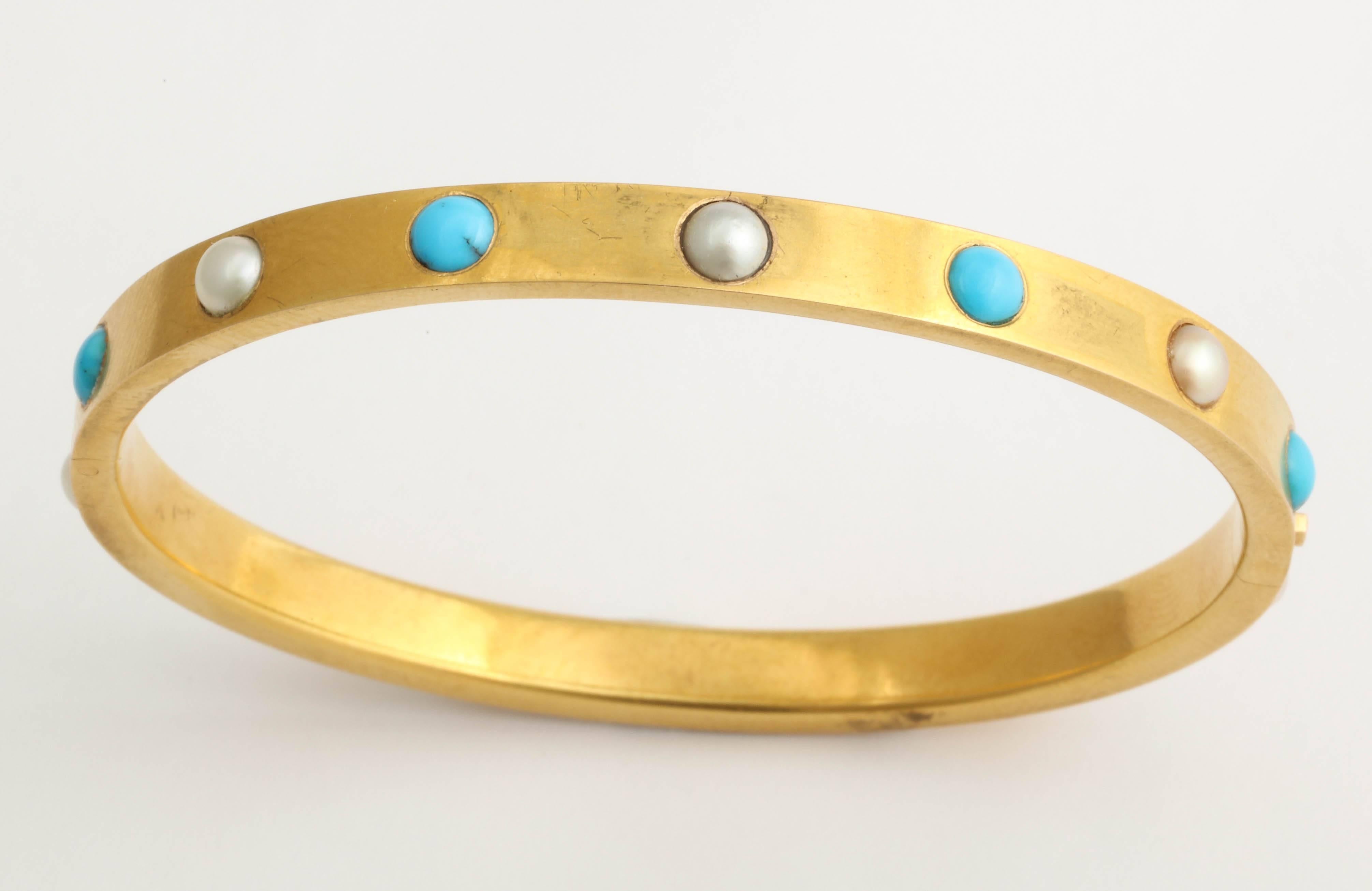This bangle is a beauty. A bright bloomed yellow gold bracelet in 18K set with alternating pearls and Persian turquoise all the way around. It dates to the 1870s-80s. The bracelet is possibly French,however it is in a fitted box for a London based