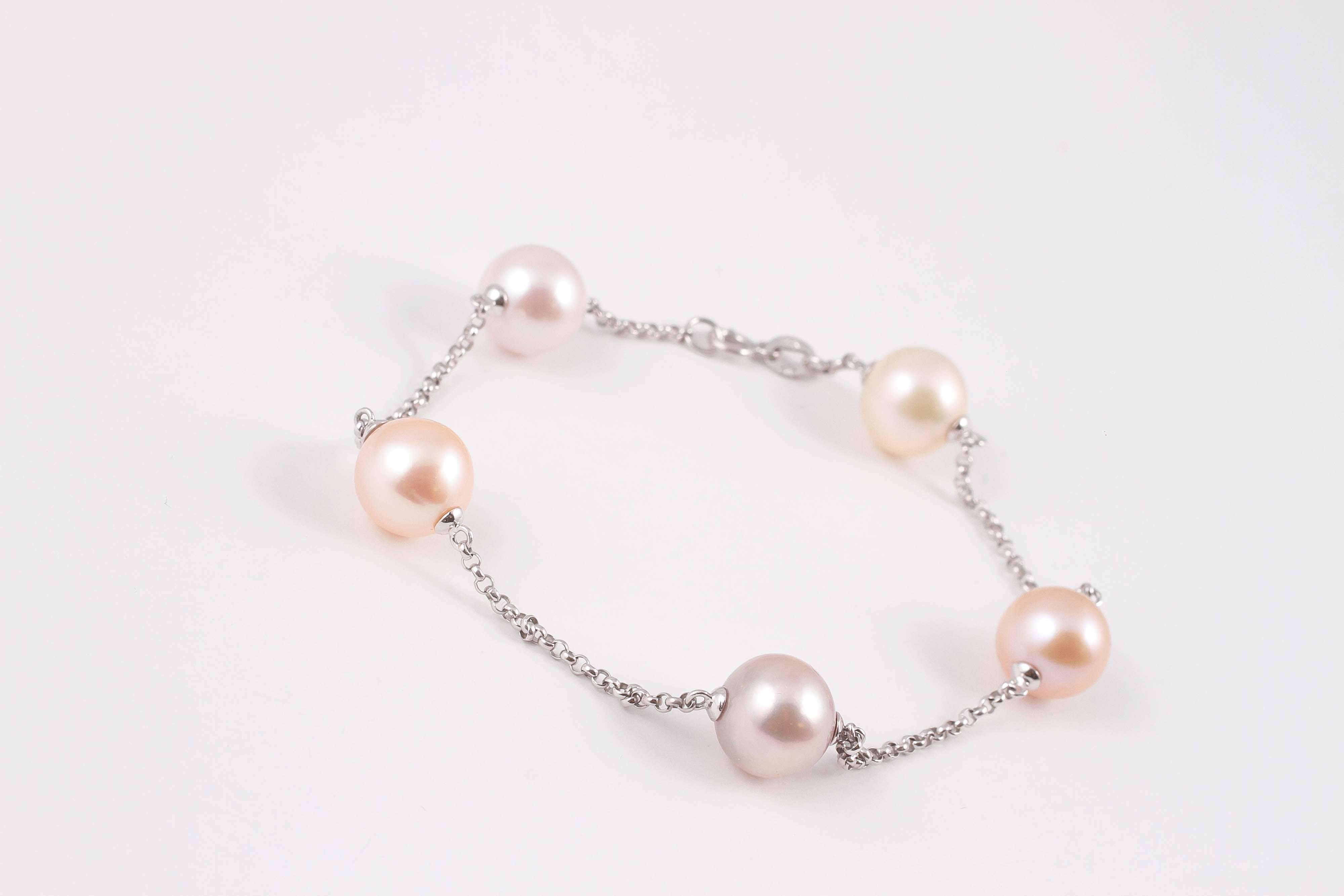Light and fun, this 14 karat white gold bracelet by Mastoloni features five soft pastel and silver - white cultured pearls, each measuring approximately 10.50 mm.