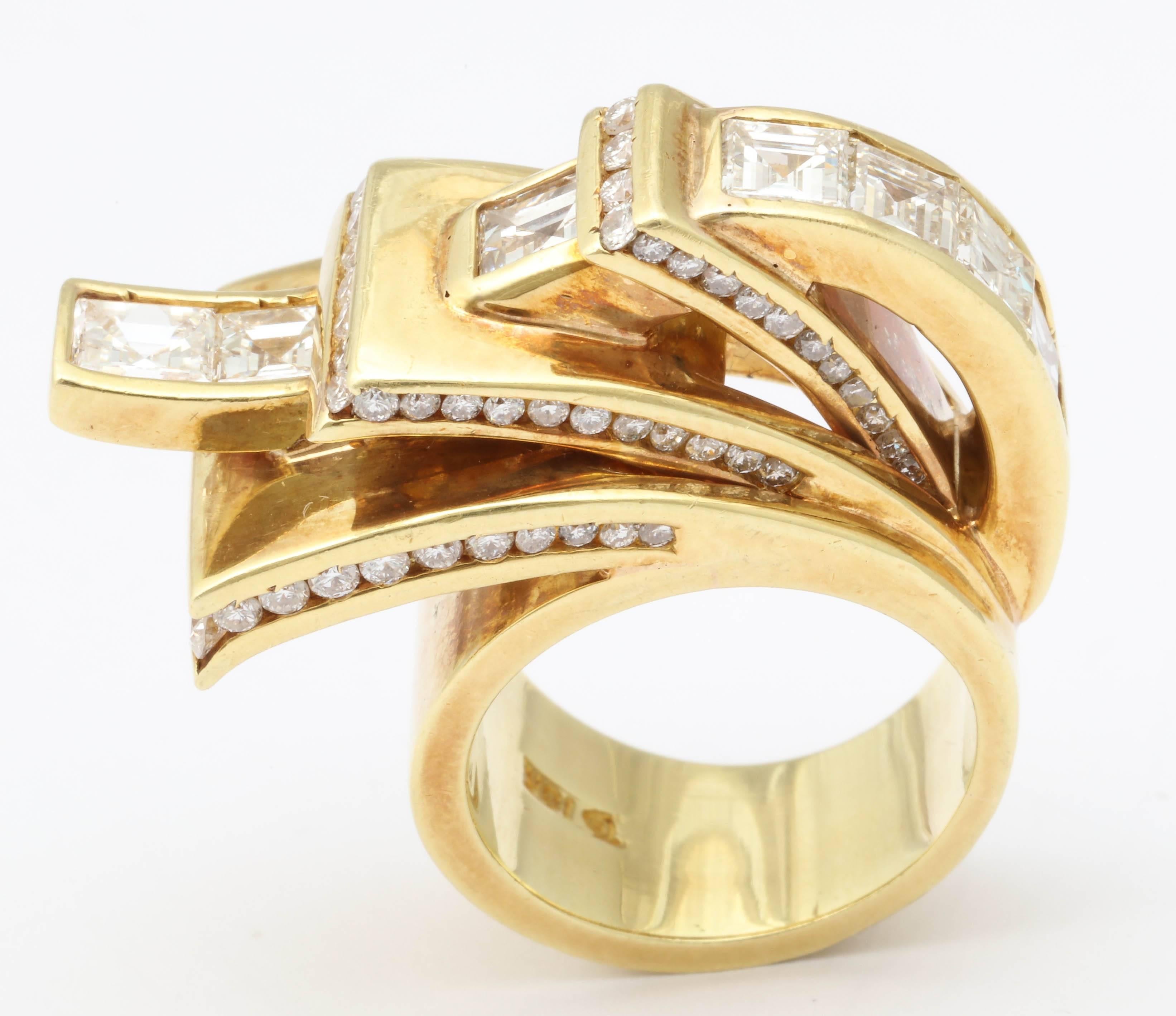 Exotic 18kt Yellow Gold multi-layer tab Ring  set with 7 super clean and white Diamond Square cuts  totaling  4.5 cts with and detailed on the sides with an additional  layer of brilliant cut Diamonds .  Signed with a D in a shield, but not