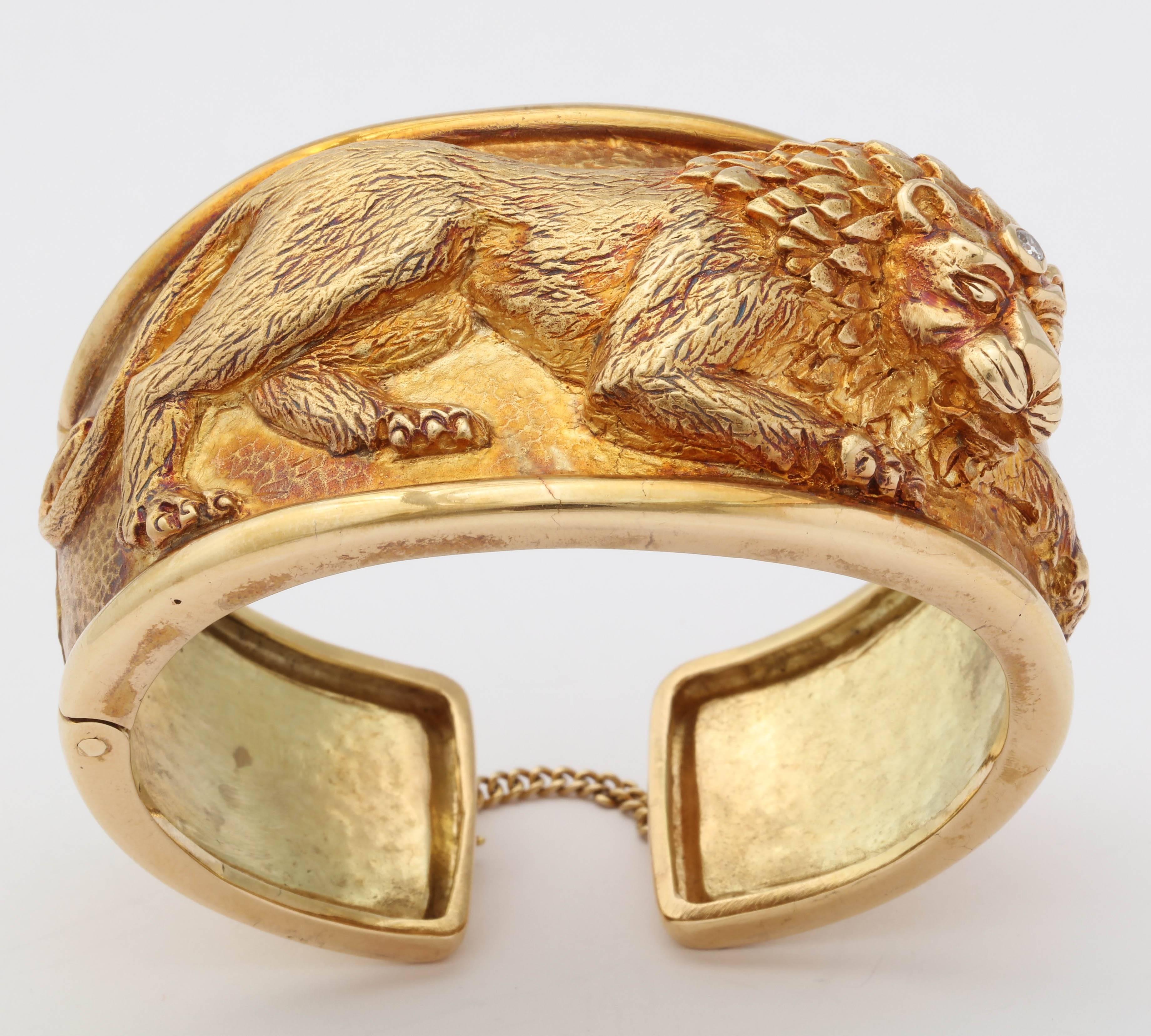 18kt Yellow Gold Cuff with a three Dimensional image of a Lion with a bezel set Diamond between  his ears.  Hinged for easy wear.  You can just hear him roarrrrrrr!