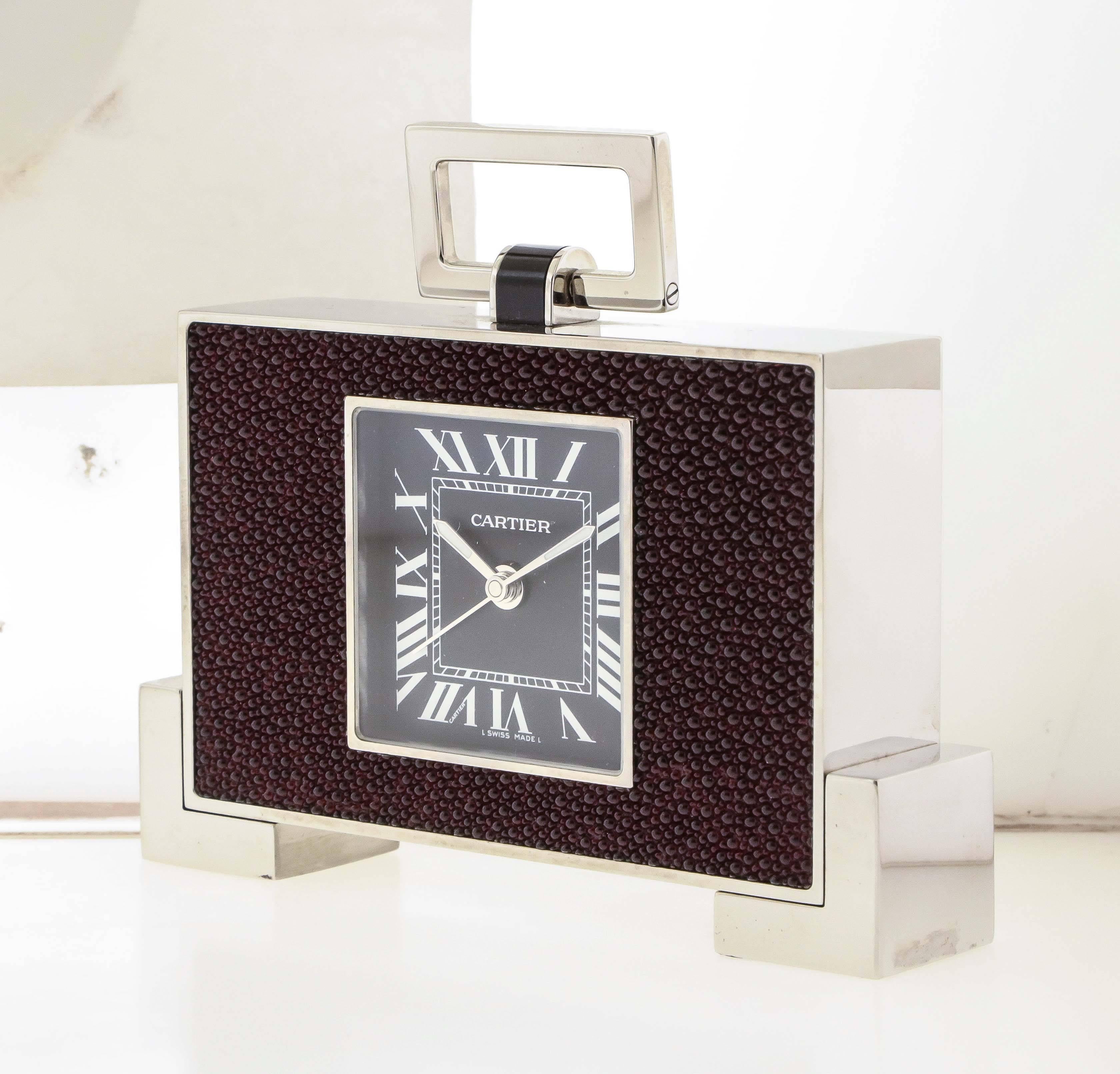 Cartier Art Deco style chromed black enamel and burgundy shagreen travelling alarm clock, circa 2005, with folding rectangular loop handle, square black dial with Roman numerals, L-shaped block feet, measures 4