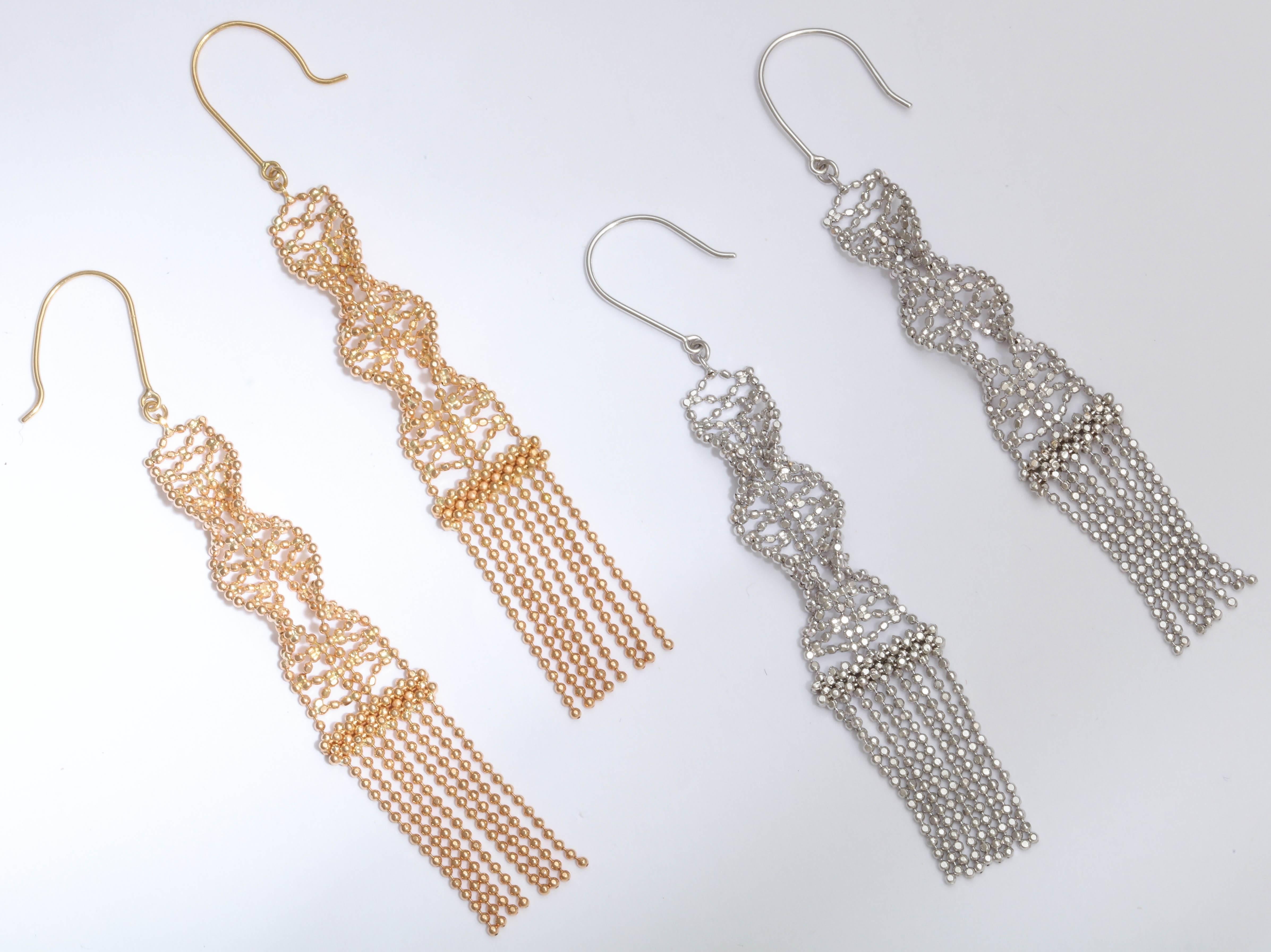 These earrings are made from fine faceted ball chain intertwined to make 2 rows of spirals. They drape beautifully from the ear and their movement makes them even sparkle more.  Available in 14 kt white gold, rose gold or yellow gold.