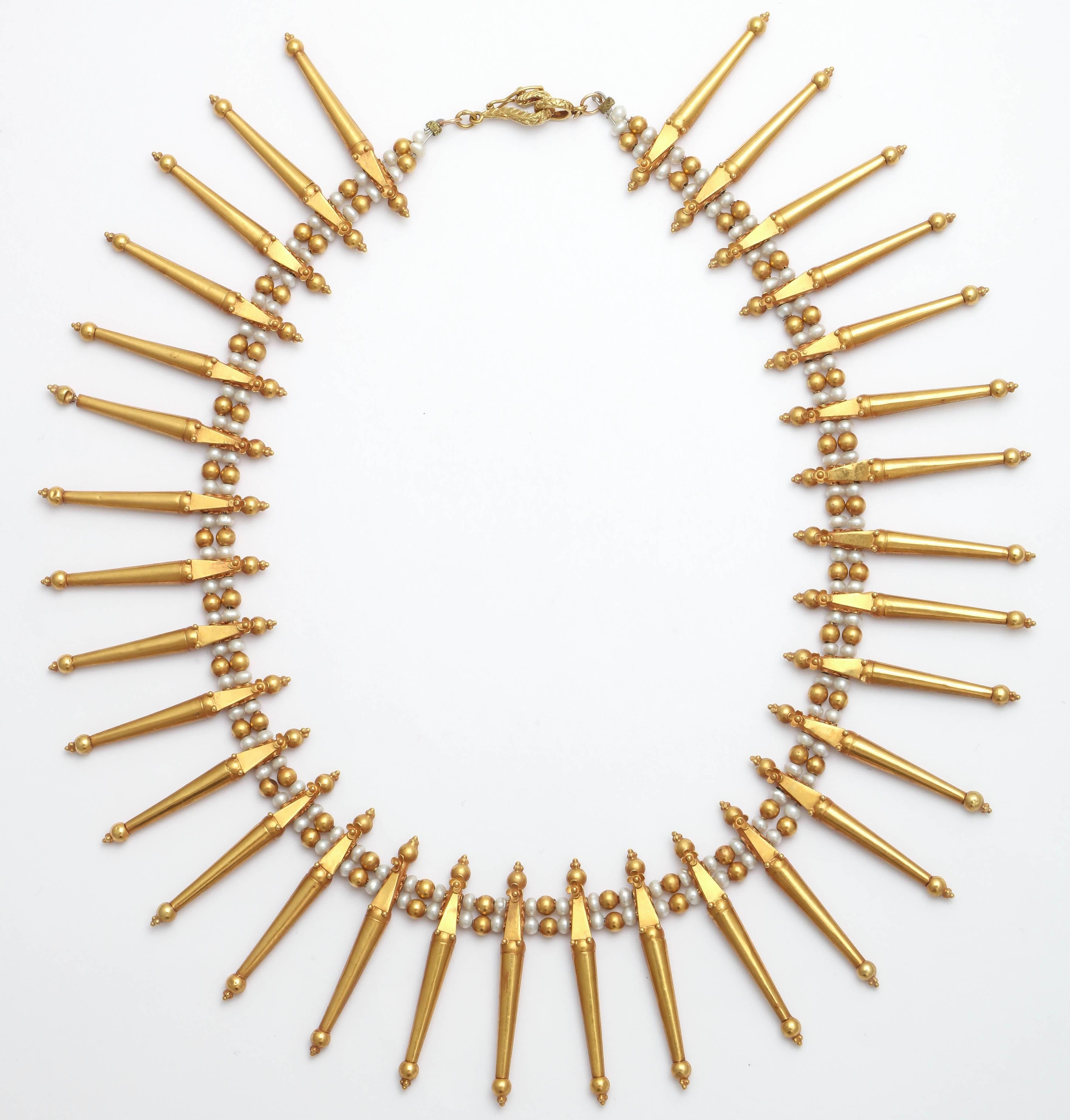 Classic and elegant Grecian style fringe necklace. The necklace has 32 'spike' components in 18 Kt gold separated by fresh water pearls and gold beads. Great for evening  wear with a toga dress or under a white shirt with your favorite jeans. The