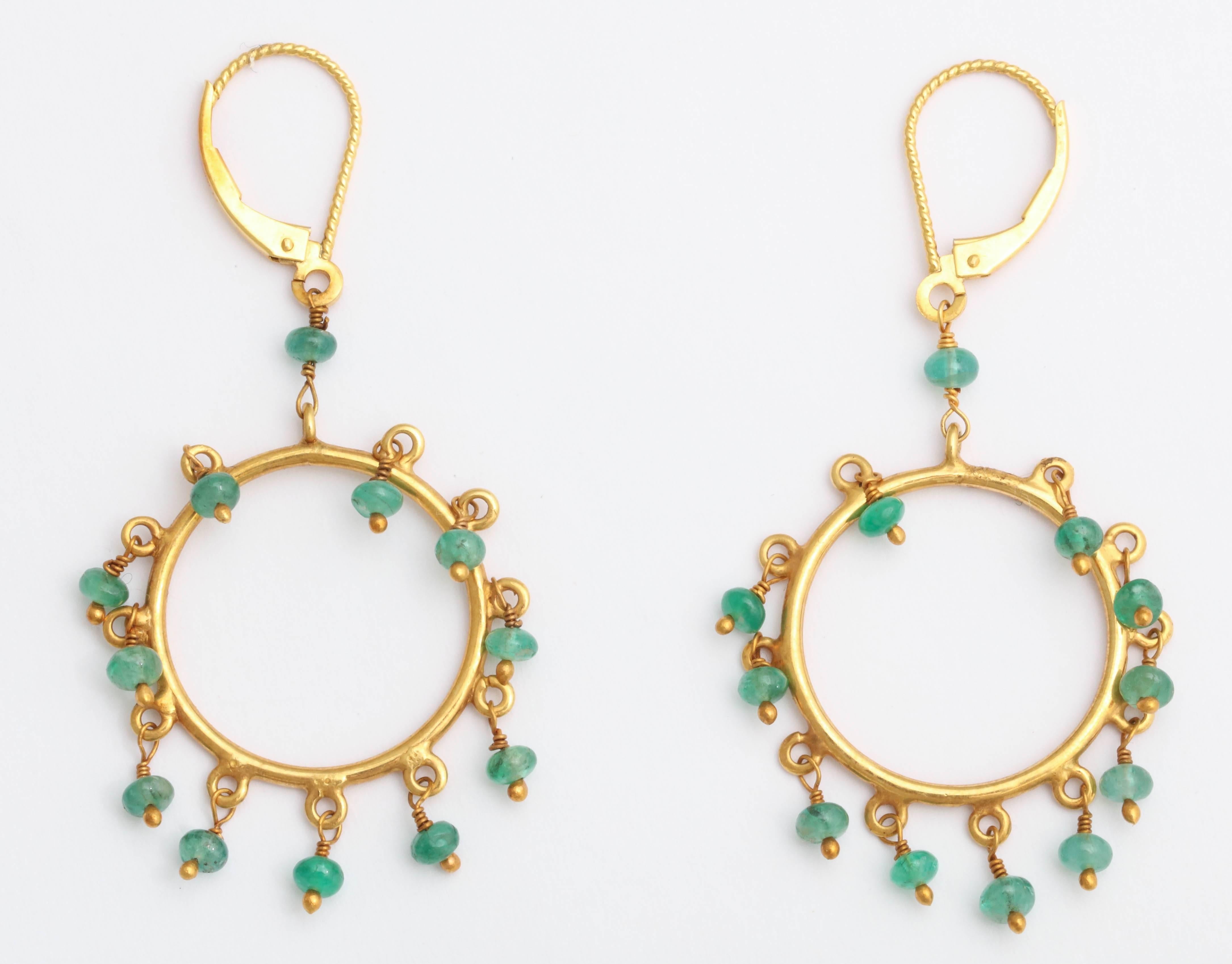 The hoop earrings dangle beautifully  from your ear. Each genuine emerald bead
is hand wired and attached to each ring for independent and graceful movement.T he earring have from a Eurowire for extra security.