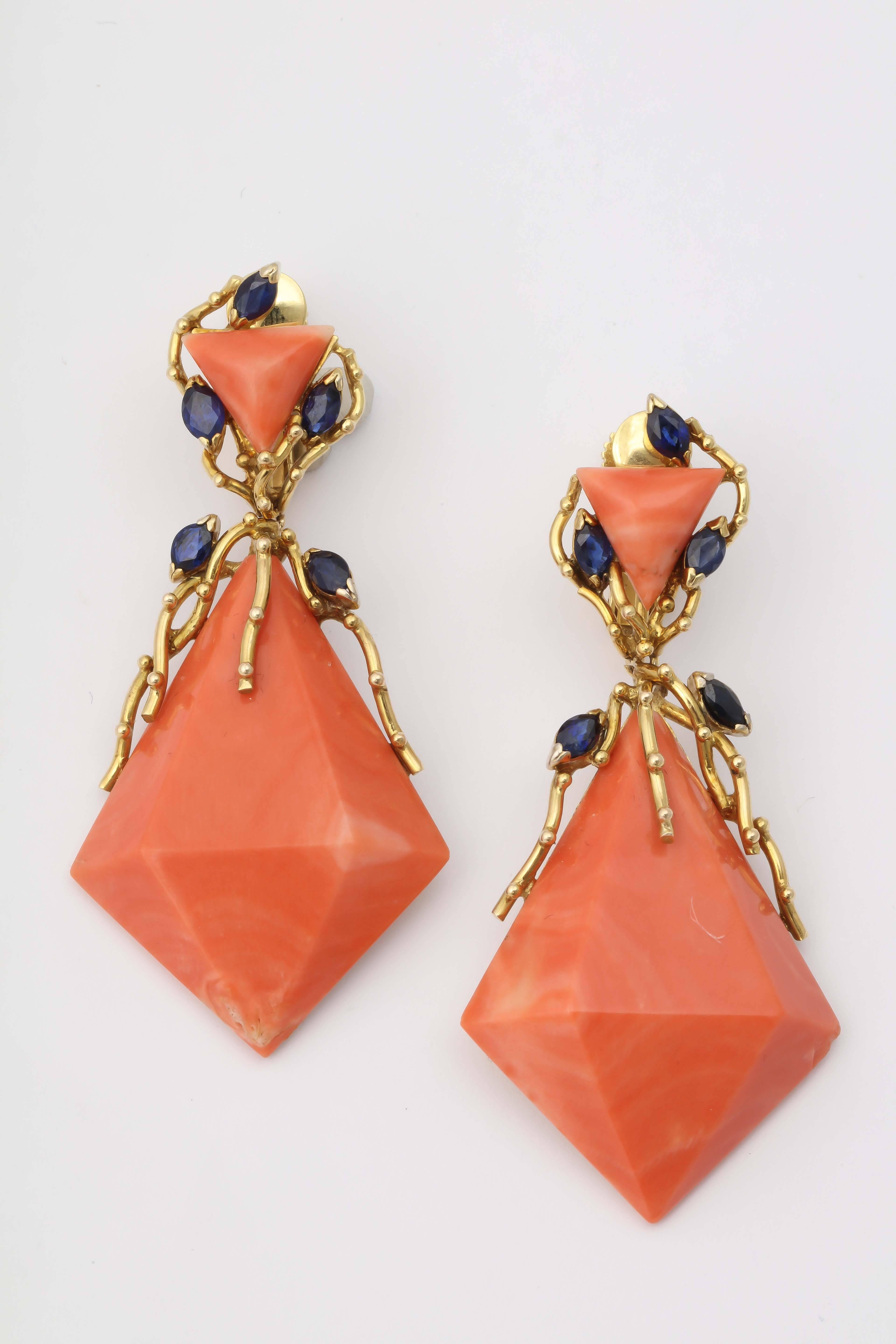 14kt Yellow Gold Hanging Drop Coral & Sapphire Earclips Designed With [10] Pear Shaped Cut Beautiful Color Sapphires Weighing Approximately 1 Carat Total Weight And Further Embellished With [2] Large Triangular Cut Coral Stones Measuring