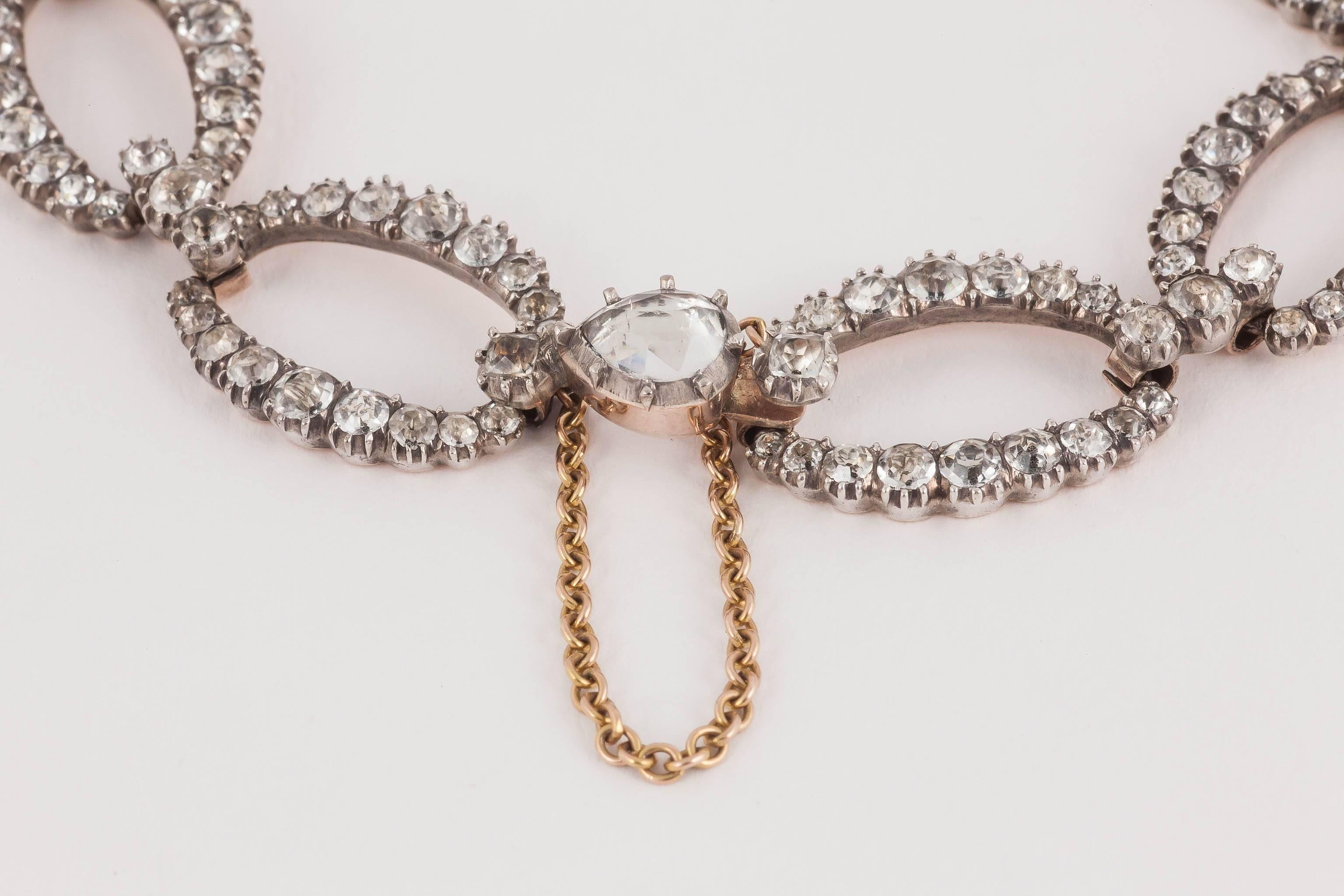A rare late George III white paste bracelet with graduated oval clusters set in silver and backed in gold, all brightly foiled. Two clasps with pear shaped paste in each.
Measures 15mm in width x 23cm in length.
Antique piece (over 100 years old)