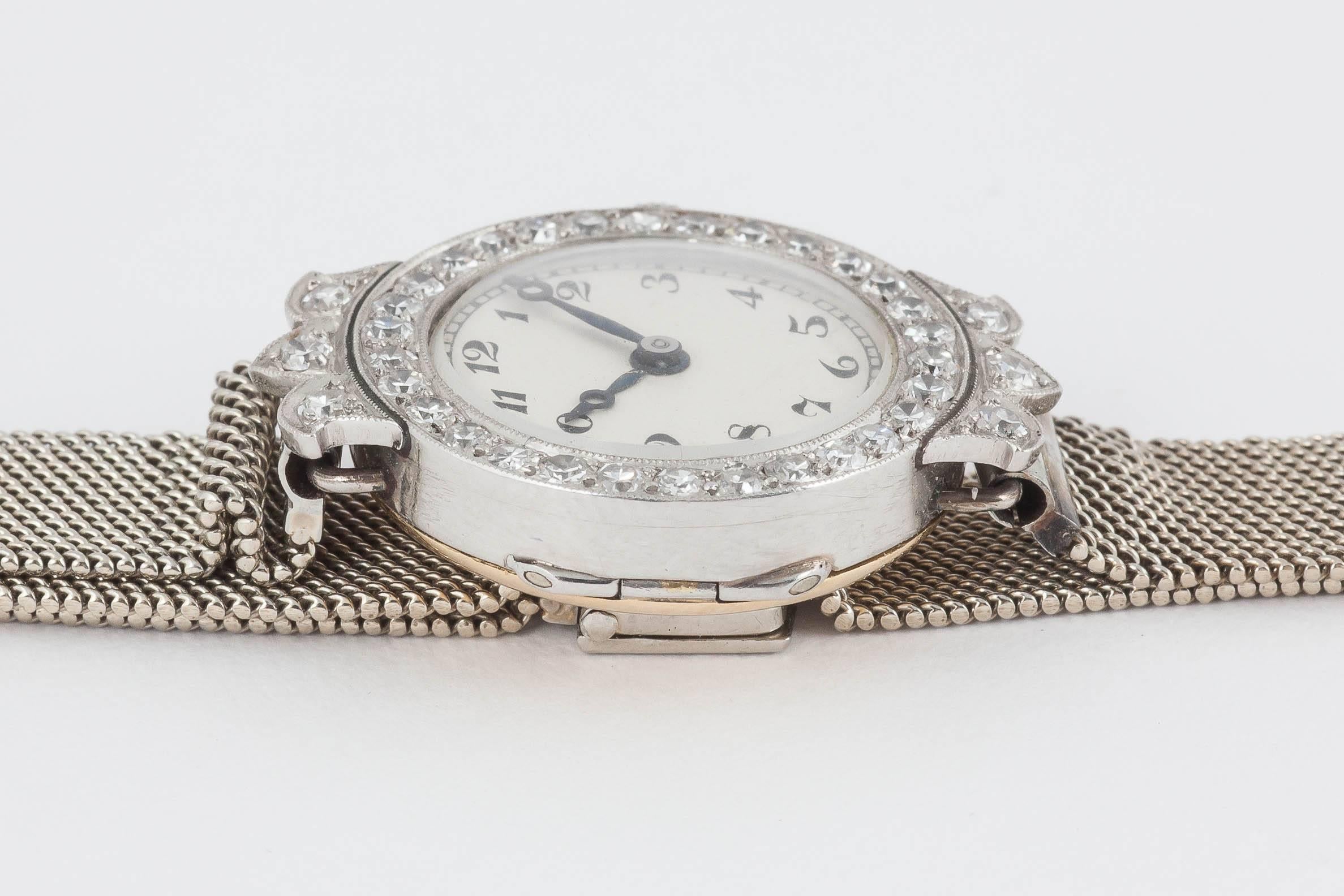 A fine quality diamond set ladies evening watch mounted in 18ct white and yellow gold, signed Goldsmiths and Silversmiths [Garrard Regent Street, London], ruby jewelled Swiss lever movement, diamond set surround and shoulders, on a Milanese