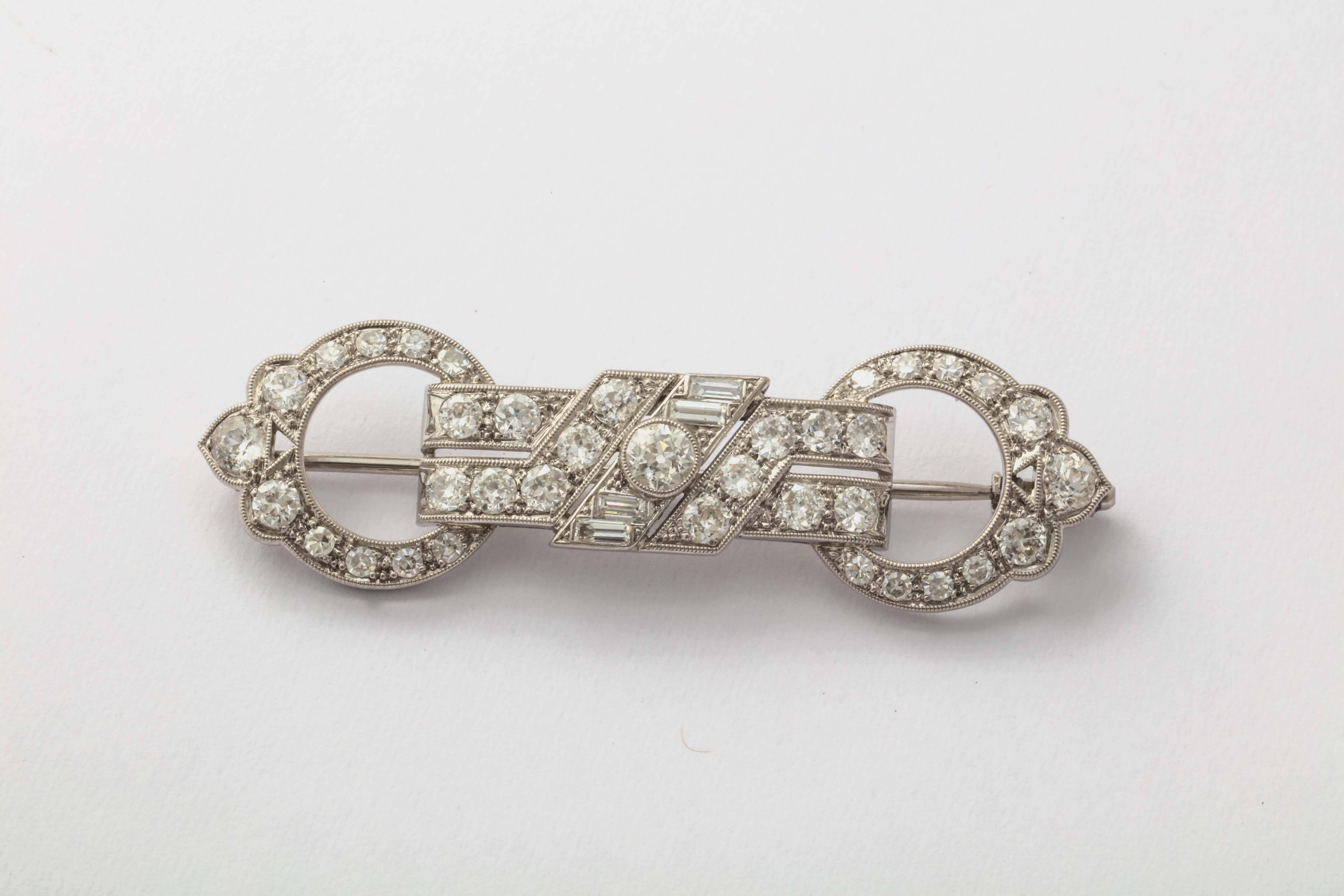 Platinum brooch with lovely openwork and milgraining. It is set with 37 Old European cut diamonds ranging in size from .05-.25cts and 4 baguette diamonds. 