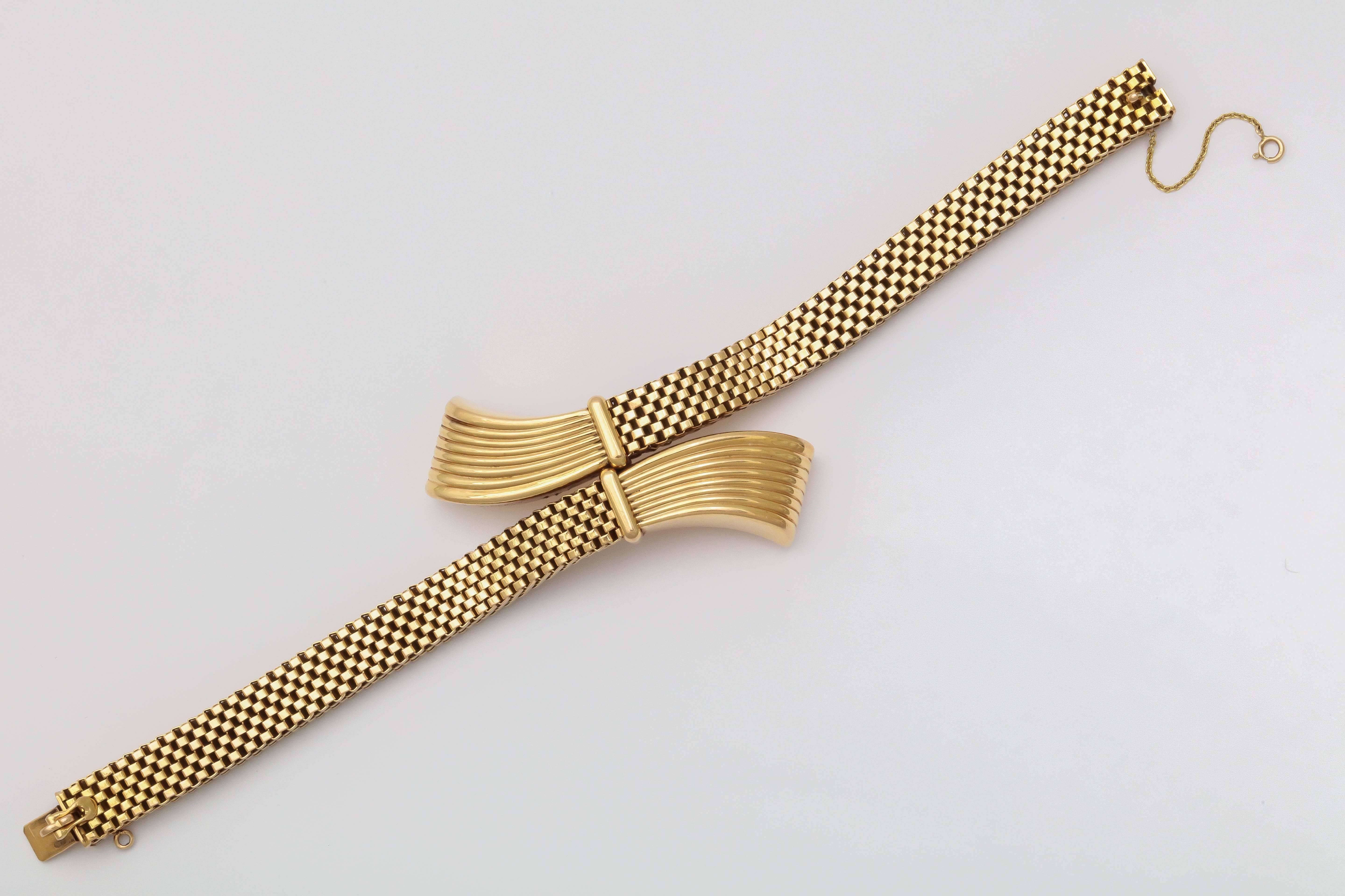 Very unusual 18kt Yellow Gold bracelet with flared & fluted ends with a tab closure. 
 Woven band and very tailored.  Restrained - but opulent.  Just short of the barest minimum - yet at the same time .... over the top Marked 750 for 18kt and the