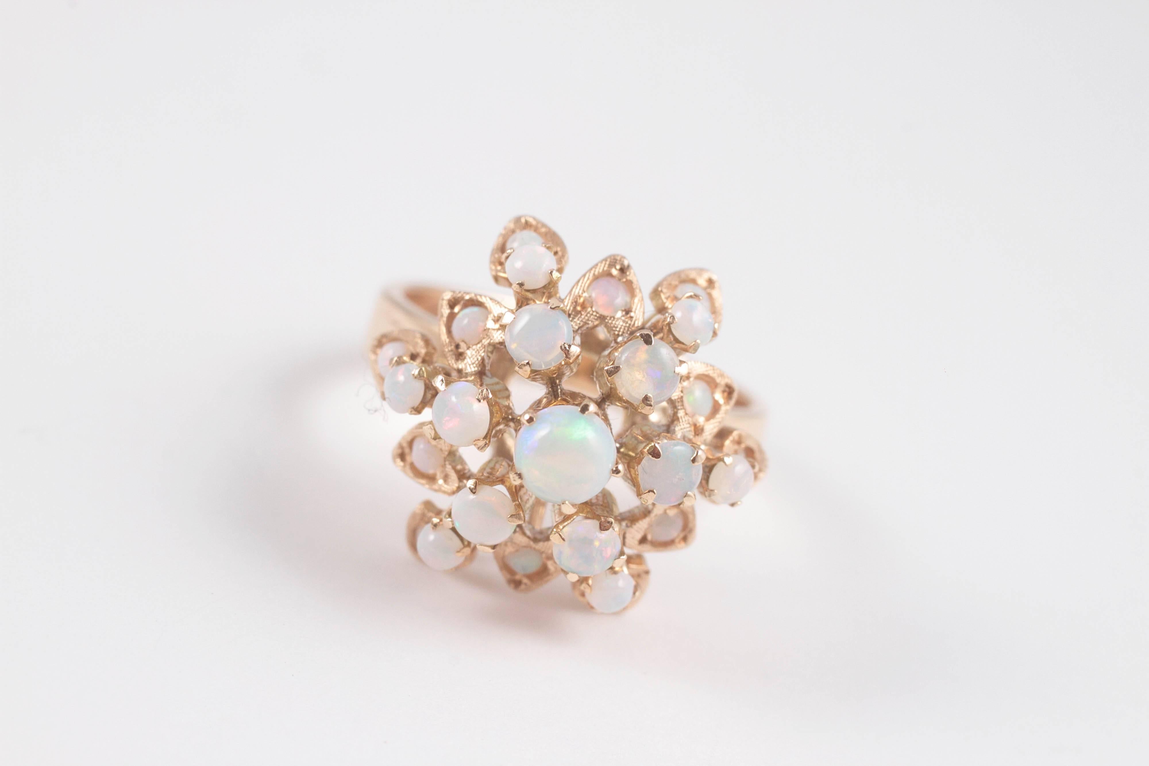 Opals with a lovely play-of-color, in 18 karat yellow gold. Size 6.75