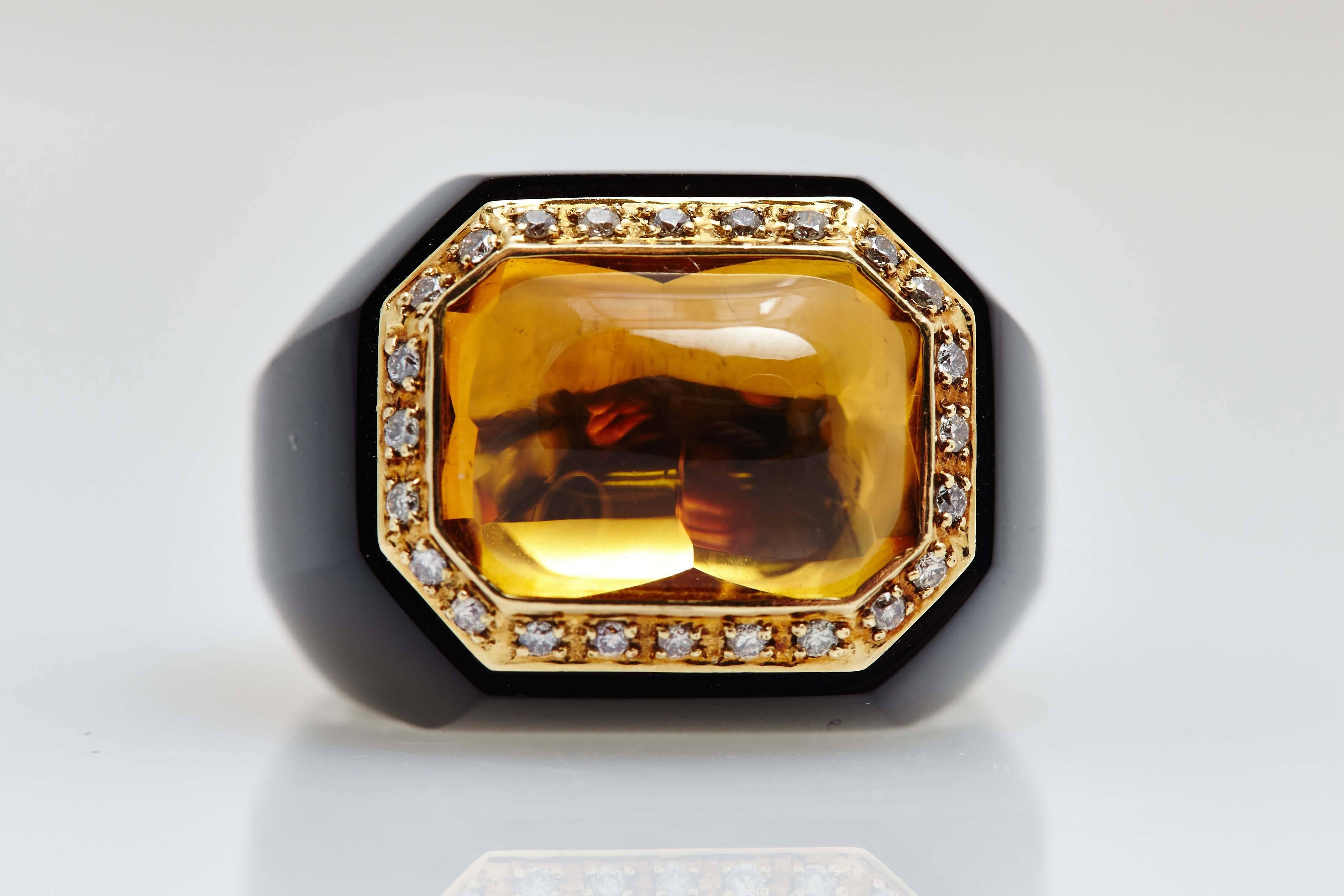 A bold cocktail ring carved out of onyx, showcasing a citrine, highlighted by diamonds, on an 18kt yellow gold mounting. Made in Italy, circa 1980. 