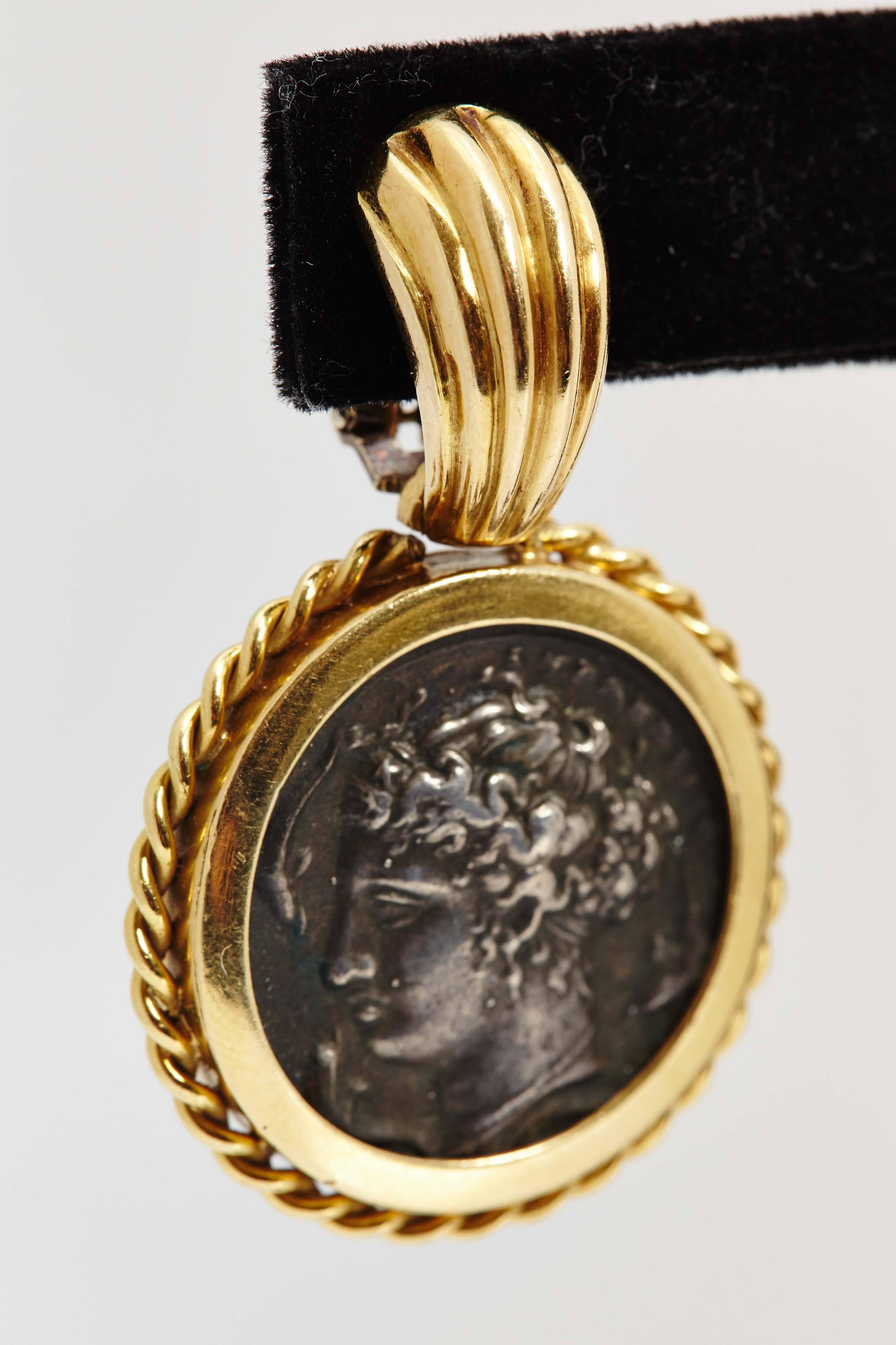 A pair of ancient roman coins ear pendants, set in 18kt yellow gold. Made in Italy, circa 1970.