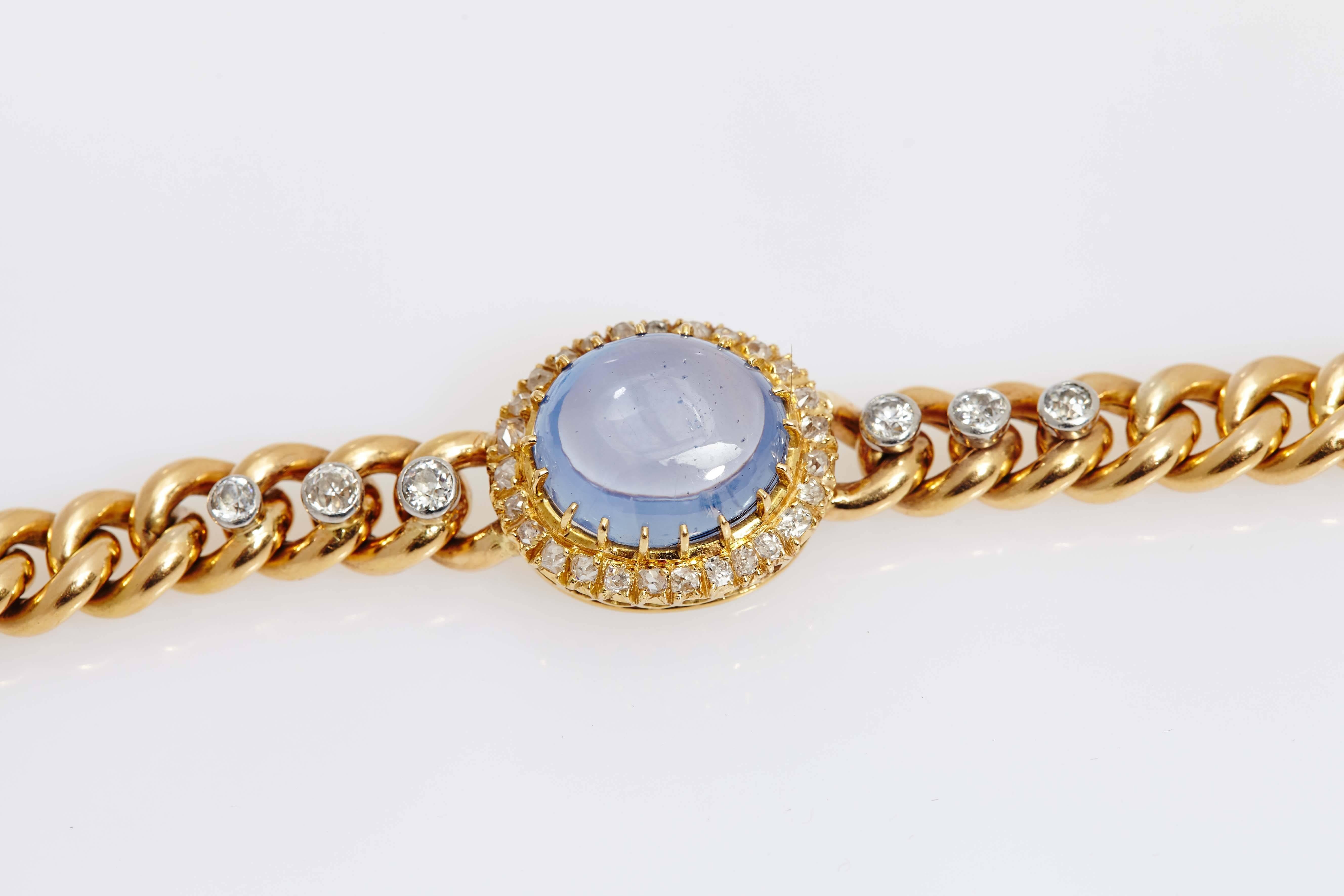 An antique 18kt yellow gold link bracelet, showcasing a 15ct Ceylon cabochon sapphire (no heat), highlighted with diamonds. Circa 1890