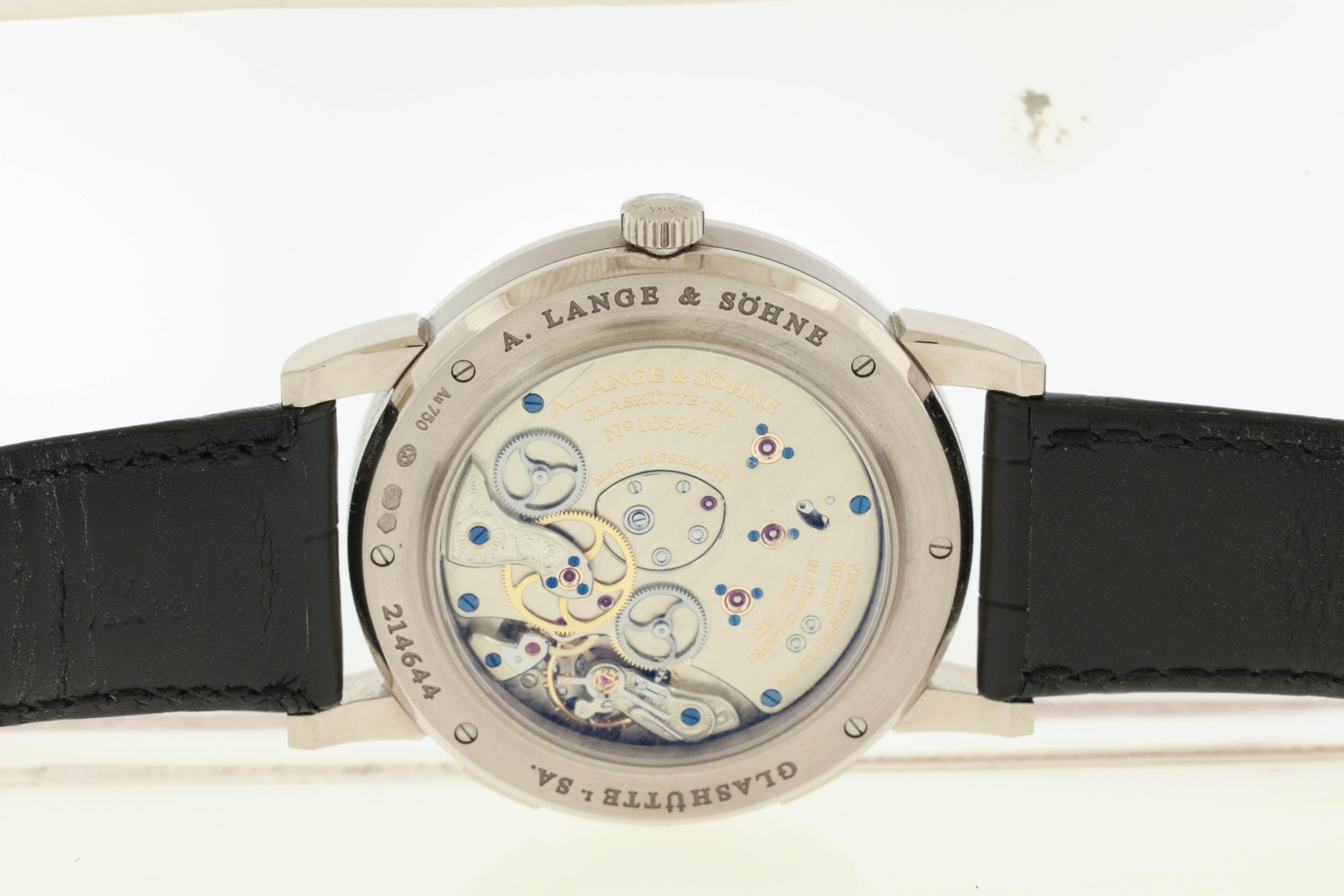 18K platinum A. Lange & Söhne twin barrel wristwatch with oversized date and power reserve, circa 1997, is a 38.5mm wristwatch with see-through back and Lange platinum buckle. The silvered matte dial features applied lozenge-shaped and Roman