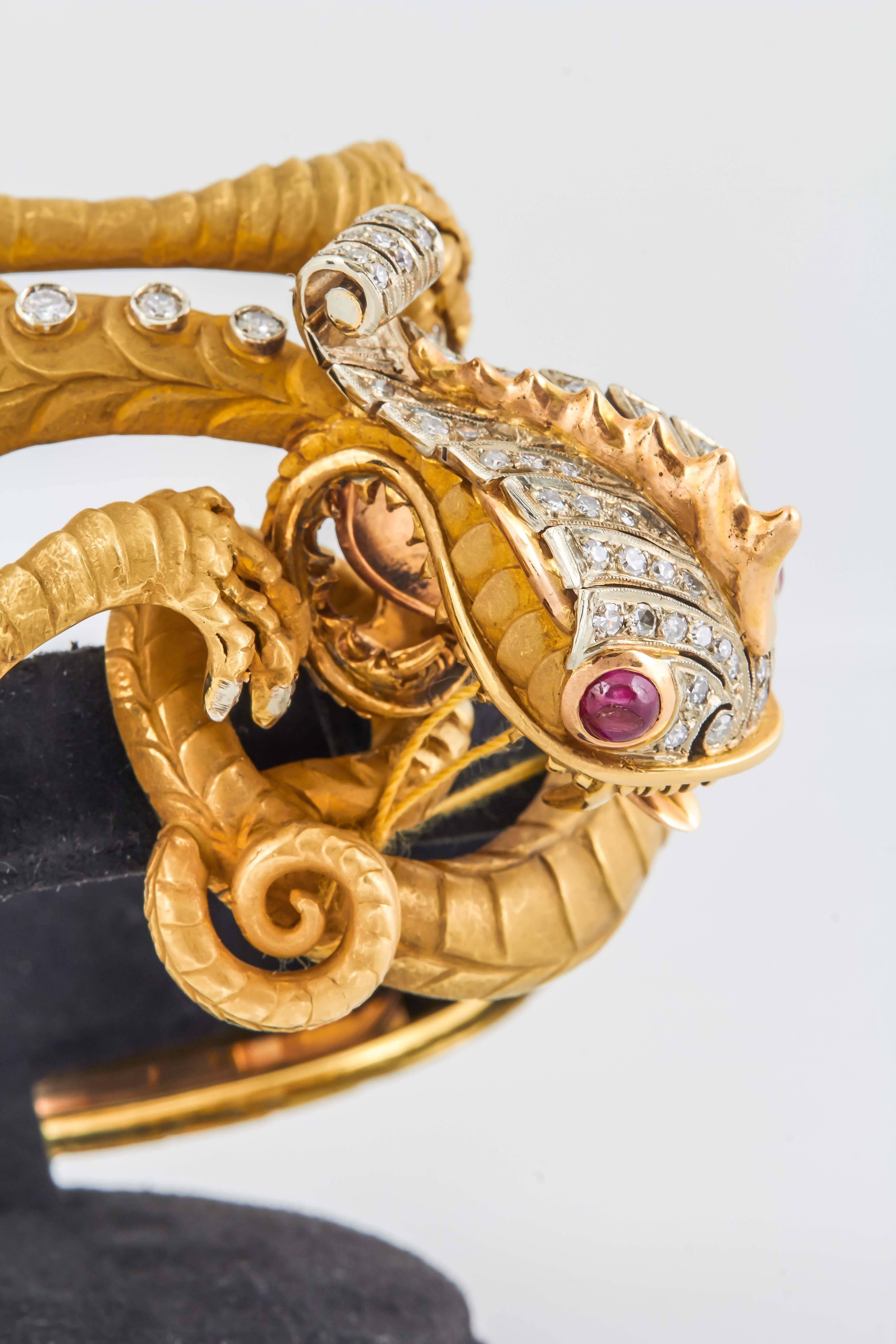 Gorgeous Dragon bracelet  finely crafted in 18k yellow gold with round brilliant cut diamonds  weighing approx. 3.35 carats and two ruby eyes.
Circa's 1960's 
75.9 dwt.
