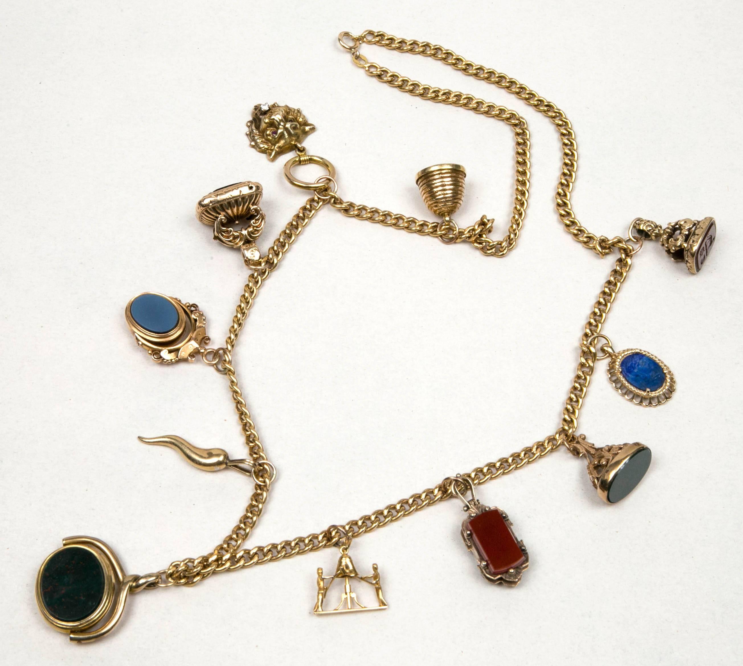 Charm-fob necklace, 18k chain from 1980's  with eleven 19th C gold fobs, some have stone intaglios, some have antique stones, and some are reversible. 
Very unusual. 
