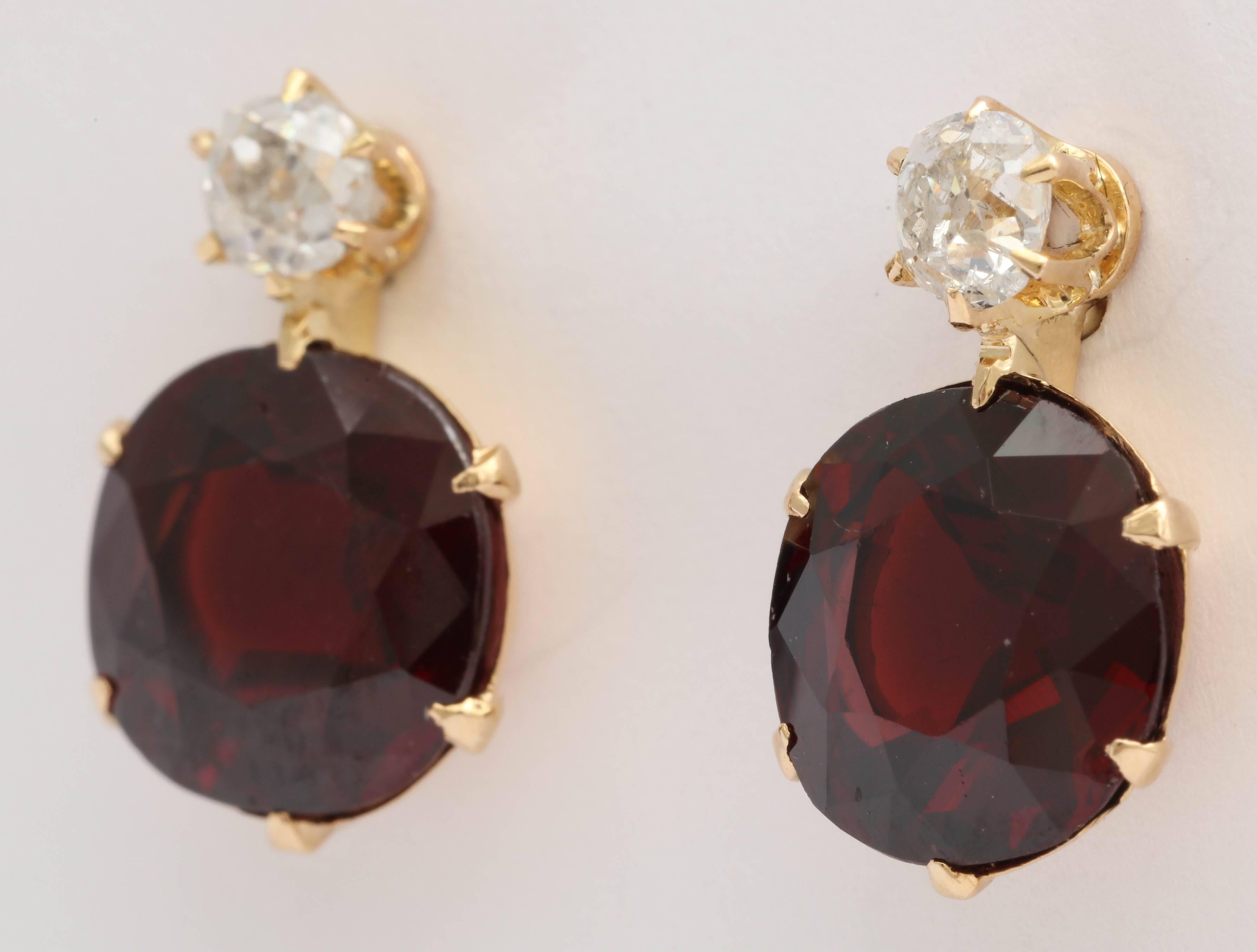 Faceted Garnet stones - Prong set in 18kt Yellow Gold & suspended from a single Prong set Old mine Diamond. Adapted to posts.
