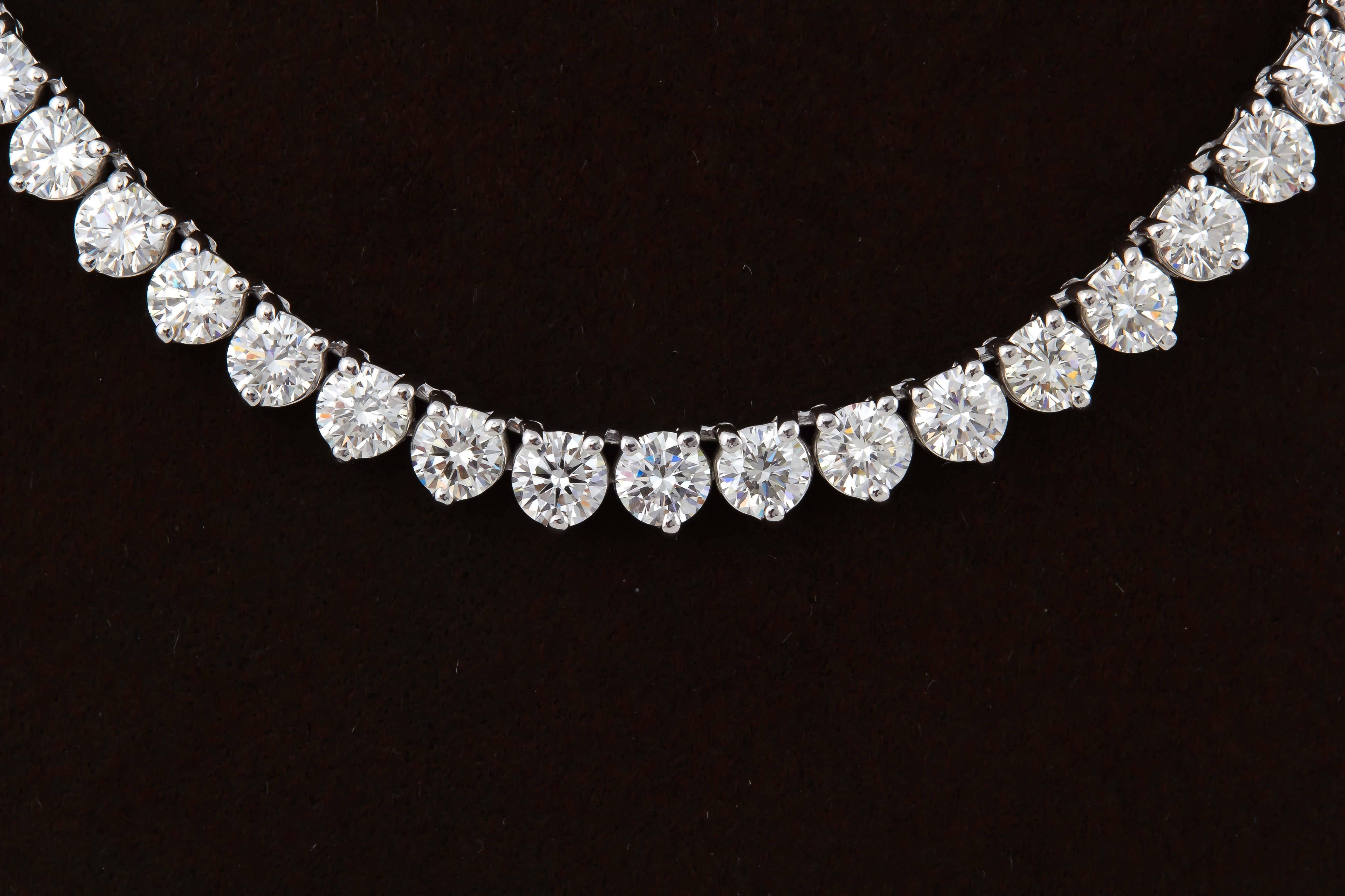
A high quality diamond tennis necklace.

24.88 carats of E/F color VS clarity round brilliant cut diamonds set in an 18k white gold three prong mounting. 

approximately 17.25 inches

This necklace is full of life and brilliance!

A