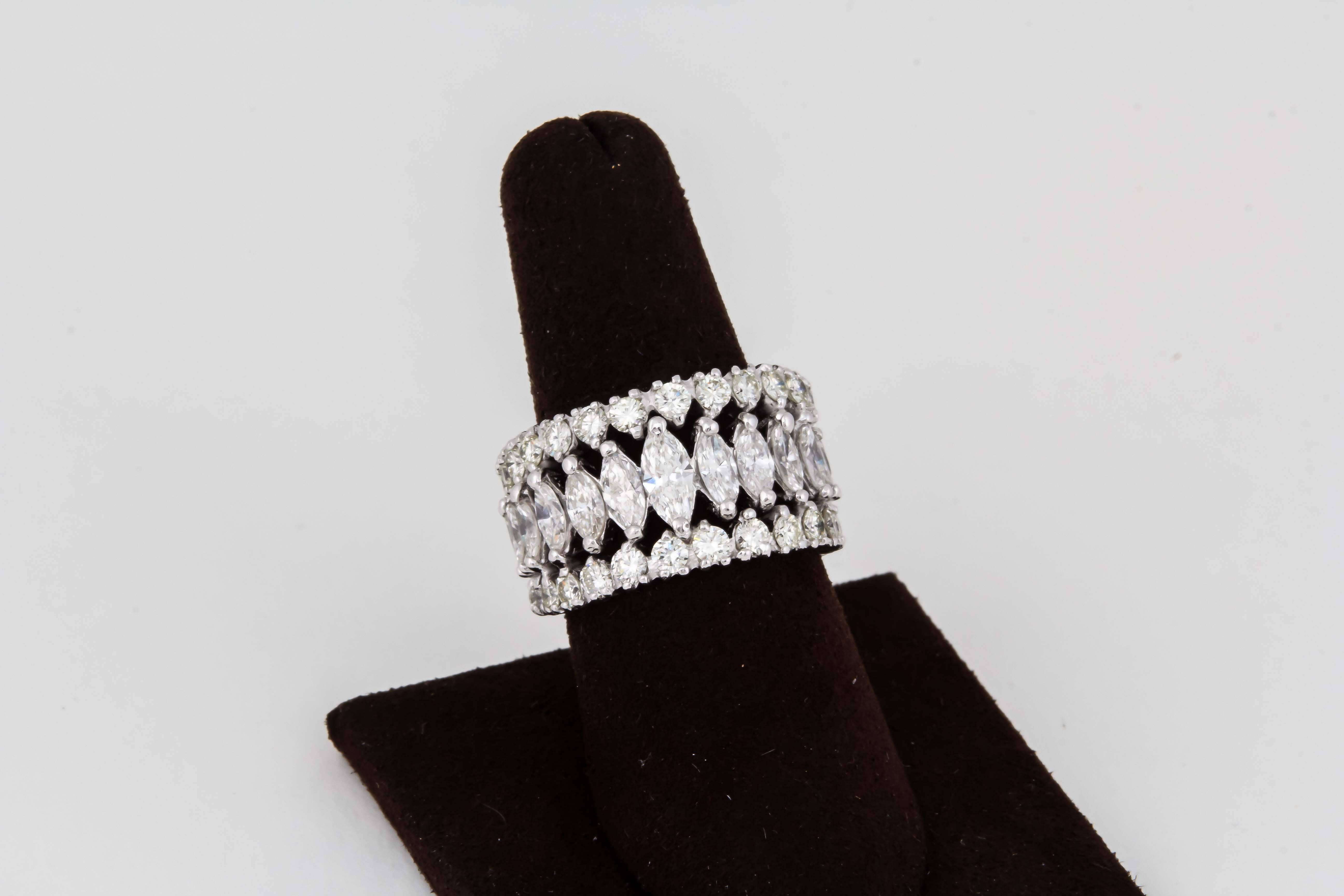 

A unique multi shape diamond band. 

8.40 carats of G color VS clarity marquise and round brilliant cut diamonds set in platinum. 

This band graduates down from its widest point at 14mm.

Finger size is 7.25 and can be adjusted. 