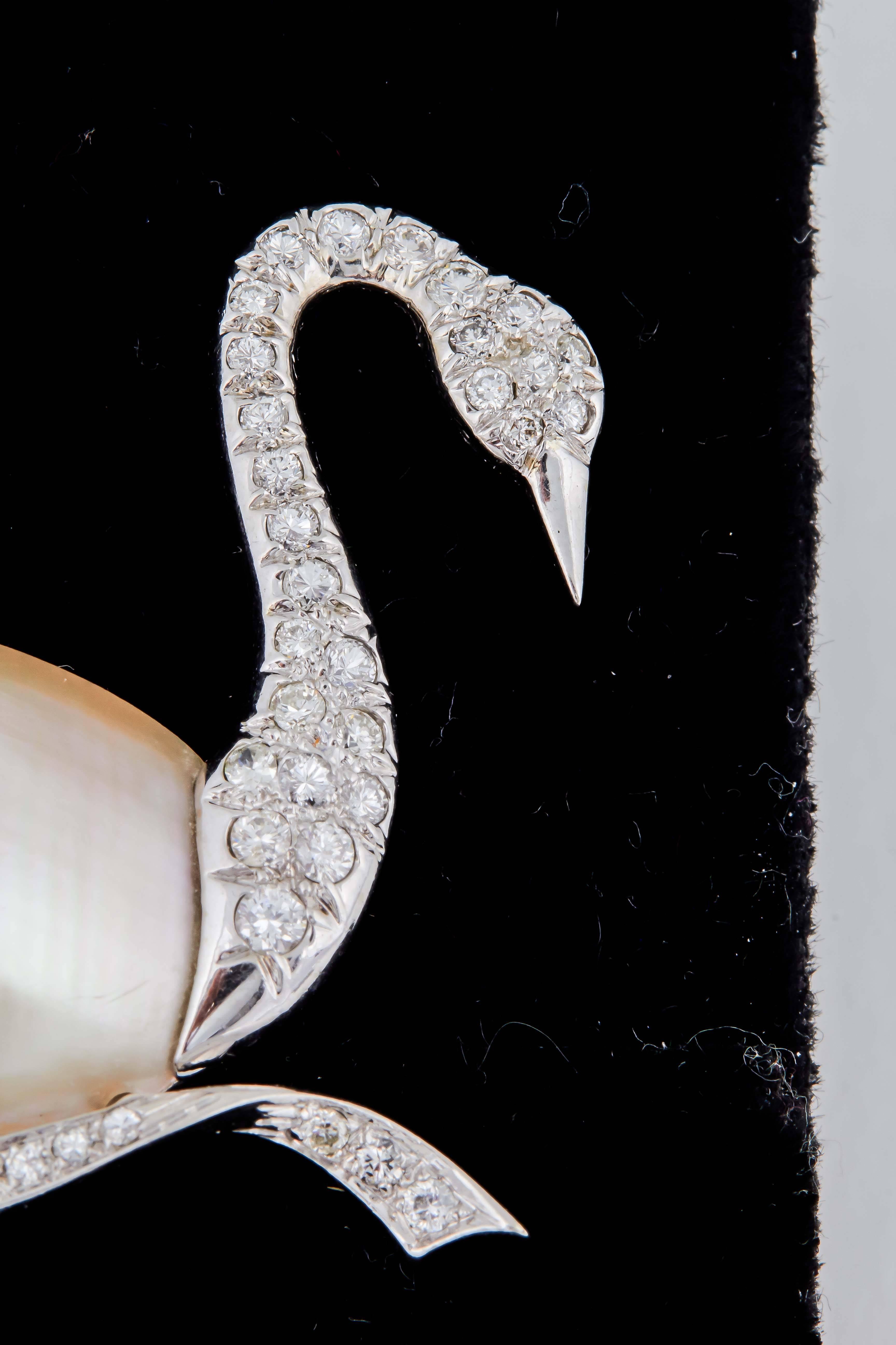 One Ladies Platinum Brooch In The Shape Of A Figural White Swan Embellished With One Large Mabe Pearl Approximately 25mm and Further Embellished With Numerous Full Cut Diamonds Weighing Approximately 1.75 cts . Made In America In The 1940's.