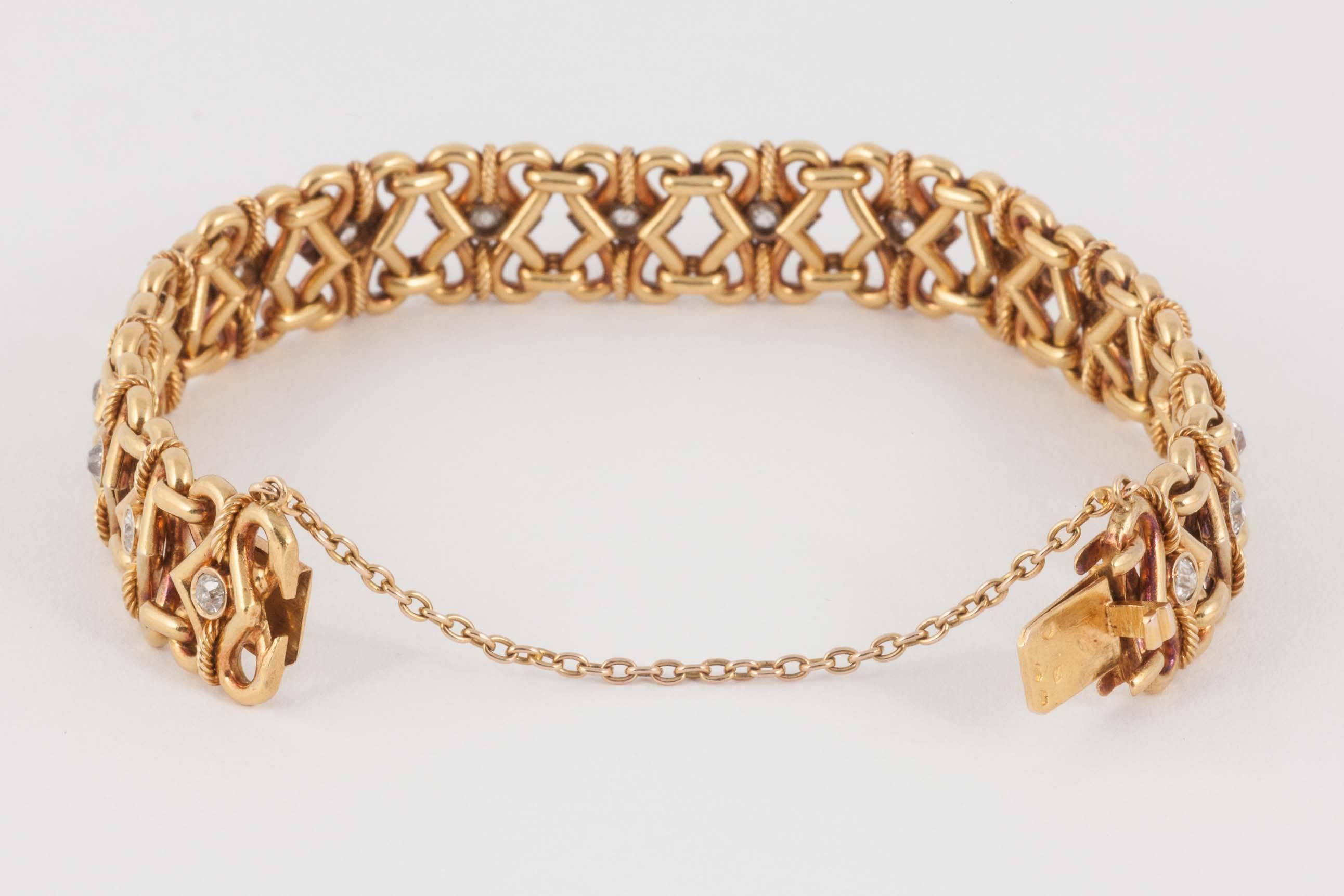 A heavy quality,French marked 18ct gold bracelet of entwined,plain and rope links set with seventeen,old cut brilliant diamonds.c,1865-70