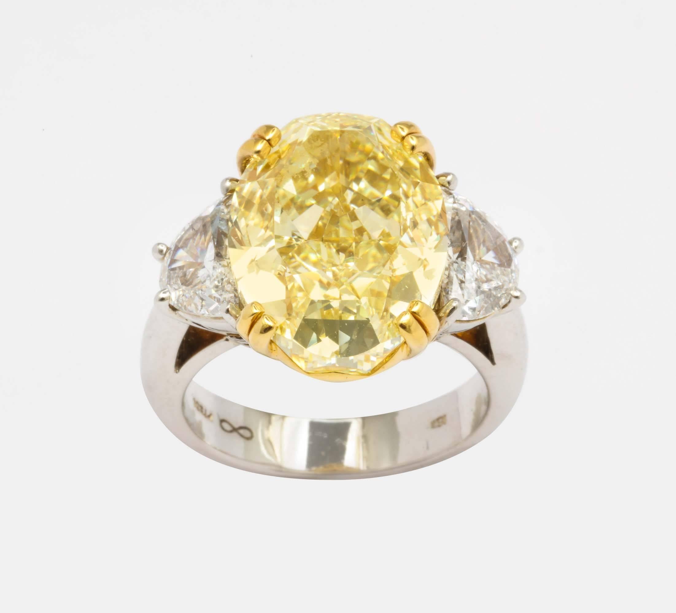 Oval Brilliant Cut diamond 10.02 carats
GIA Color Rating: Fancy Yellow
GIA Clarity rating: SI1
Modern Cut
Flanked by 2 Half moon shaped diamonds approx 2.00 carats
GIA report # 14613959 on request