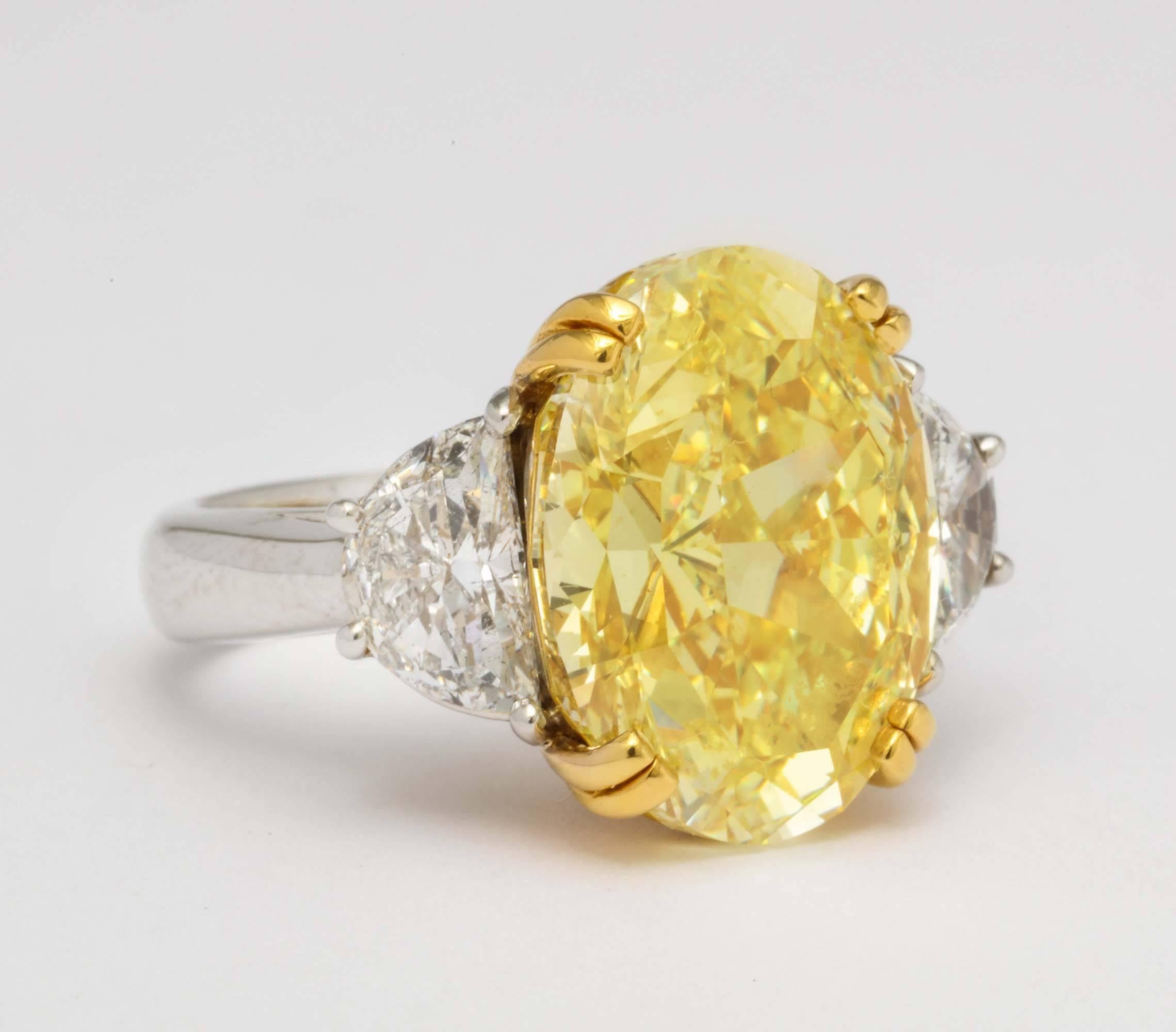 Contemporary Platinum Gold and Fancy Color Oval Diamond Ring