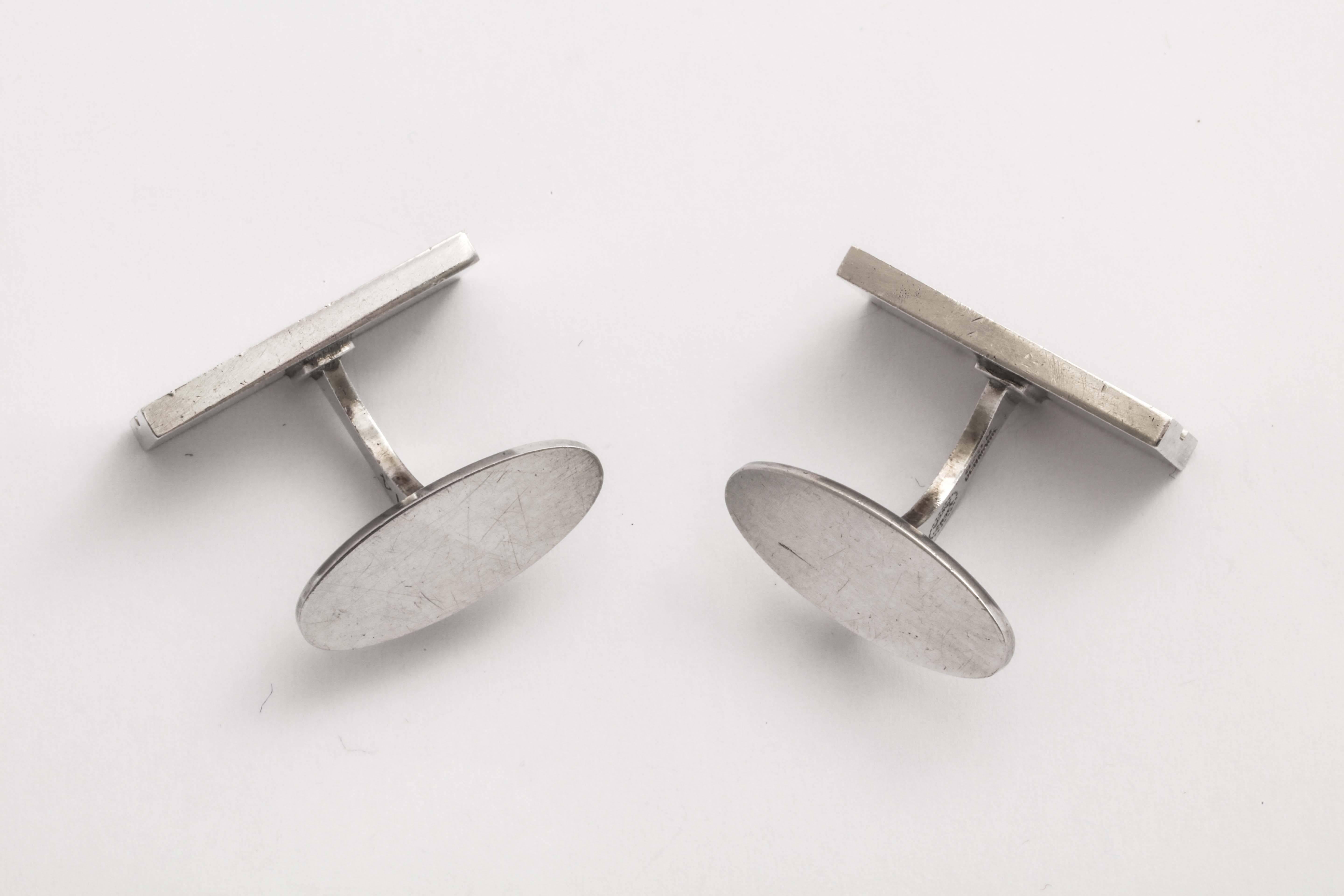 Rectangular with indention down the center and with toggle fastener.
Impressed GEORG JENSEN in oval/ 925 S/ DENMARK/ 114.