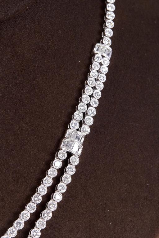 
A timeless diamond necklace with a vintage feel.

11.64 carats of F/G VS round and baguette cut diamonds set in platinum. 

The round diamonds are bezel set with beading.

Approximately 16 inches in length that can be adjusted if necessary.  