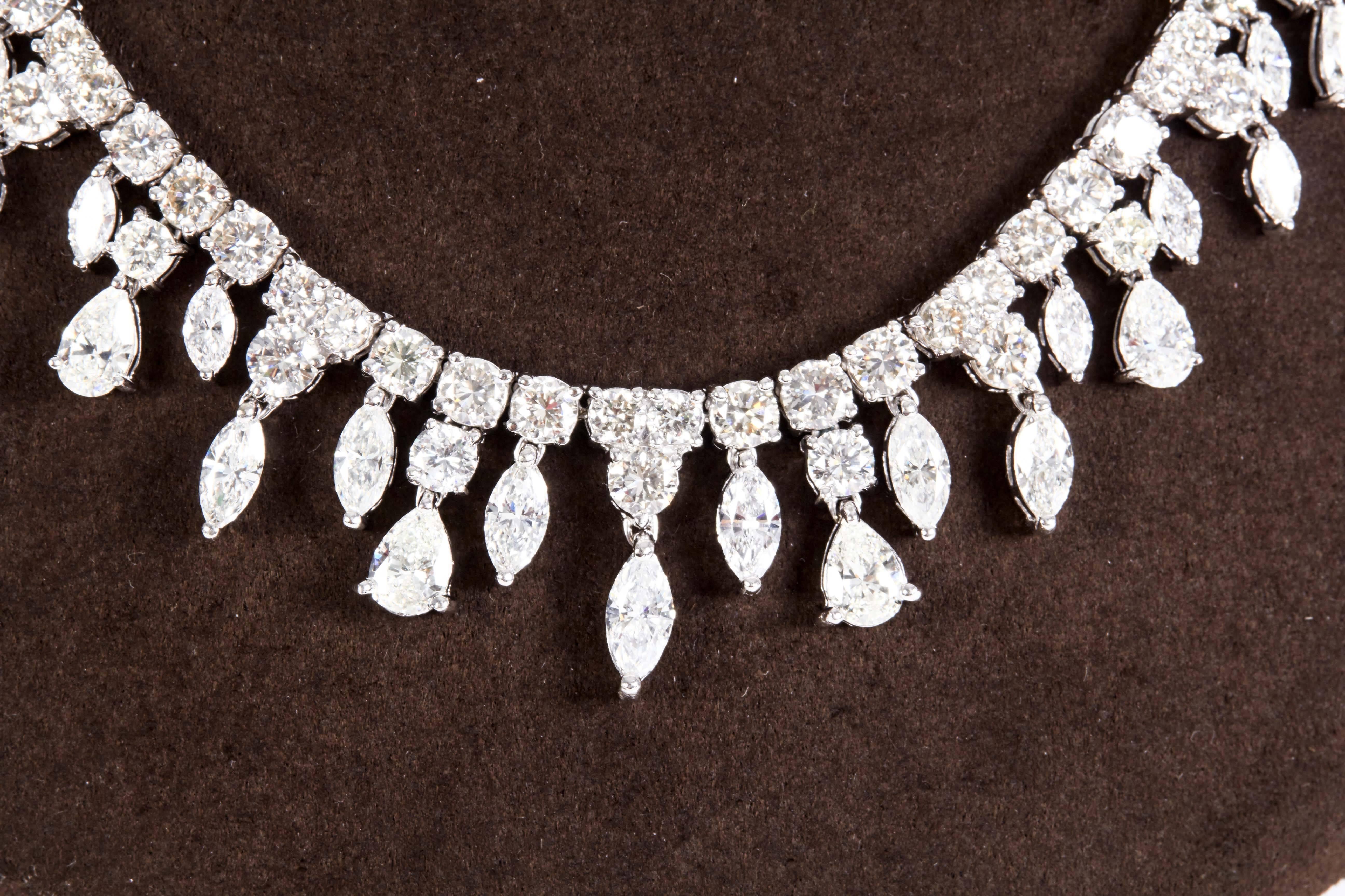 

A unique design! 

Large pear and marquise shaped diamonds hanging from a multi size round diamond choker. 

46.62 carats of near colorless white VS clarity diamonds set in 18k white gold. 

Currently a 16 inch length but can be altered. 