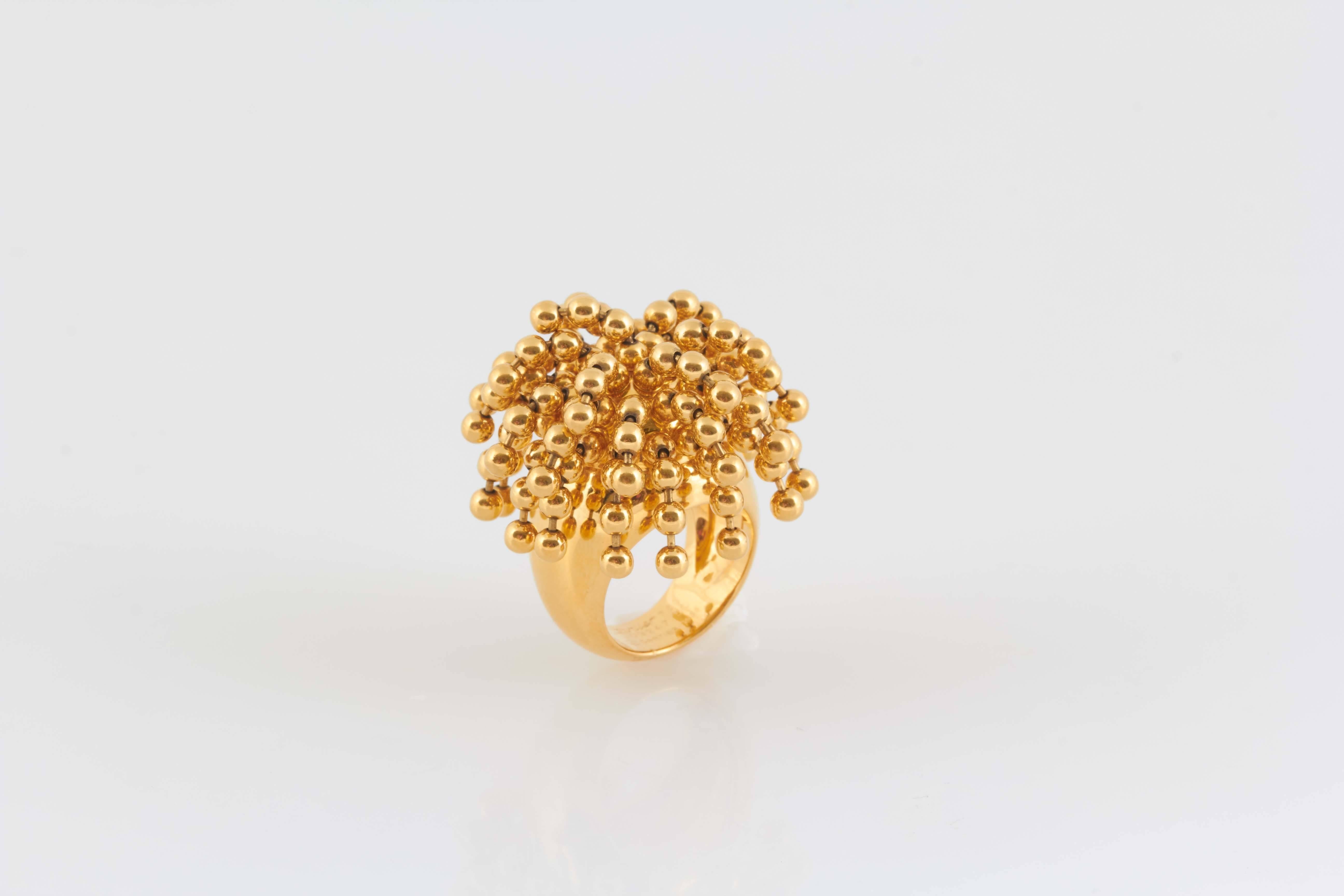 Nouvelle Vague Perruque Ring finely crafted in 18k yellow gold.  Having good weight and lots of Movement a very unusual and very fun ring. Signed by CARTIER. Number #J03247 50. Circa 1999.
